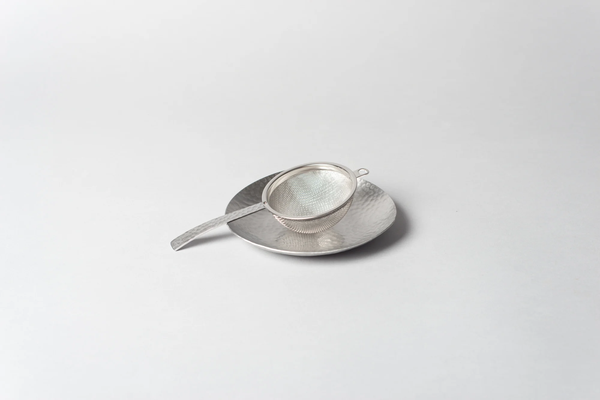 native&co-hammered-tea-strainer-and-saucer