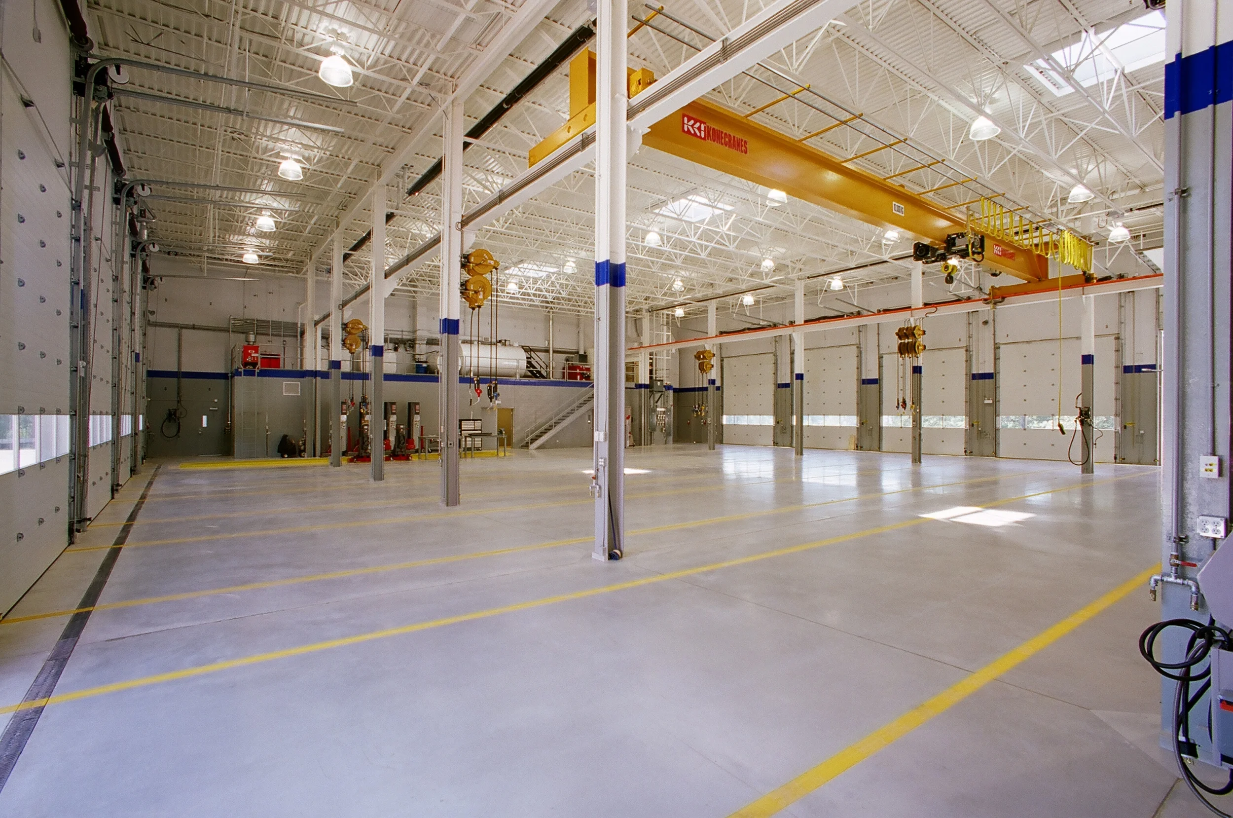  Concrete floors in service shop featuring enhanced light reflective finish. &nbsp;Overhead crane for heavy lifting of truck equipment for servicing. 