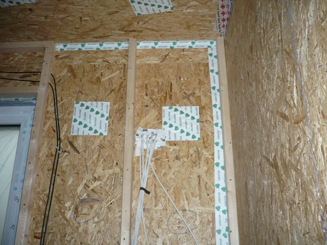 Air and vapour sealing on the inside face of the exterior wall. A second 2x4 wall is provided for running building services to avoid penetrations in order to achieve incredibly low building envelope air changes.