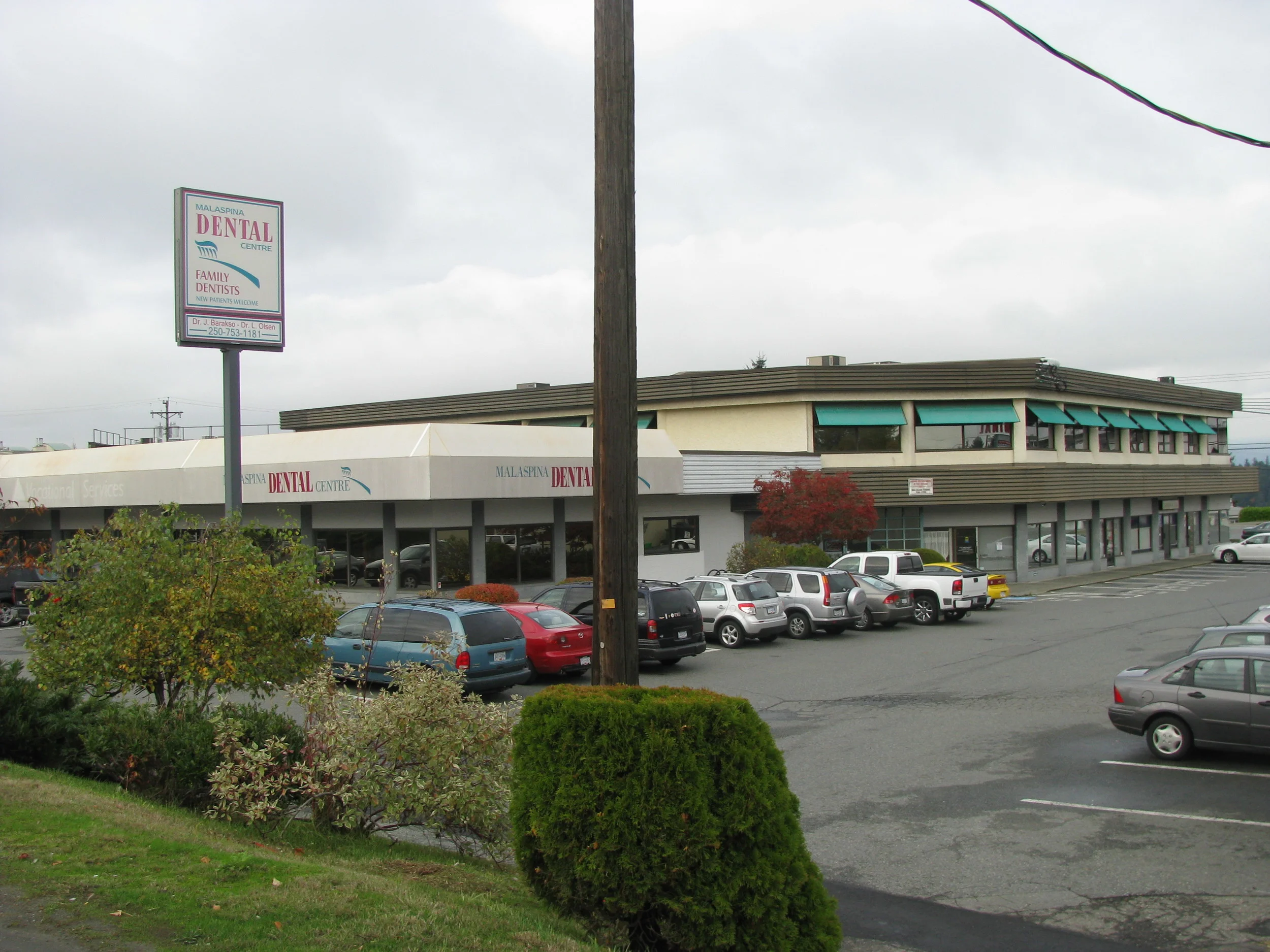  Exterior facade from highway prior to minor exterior renovations. &nbsp;Featured backlit fabric canopies and little landscaping.&nbsp; 