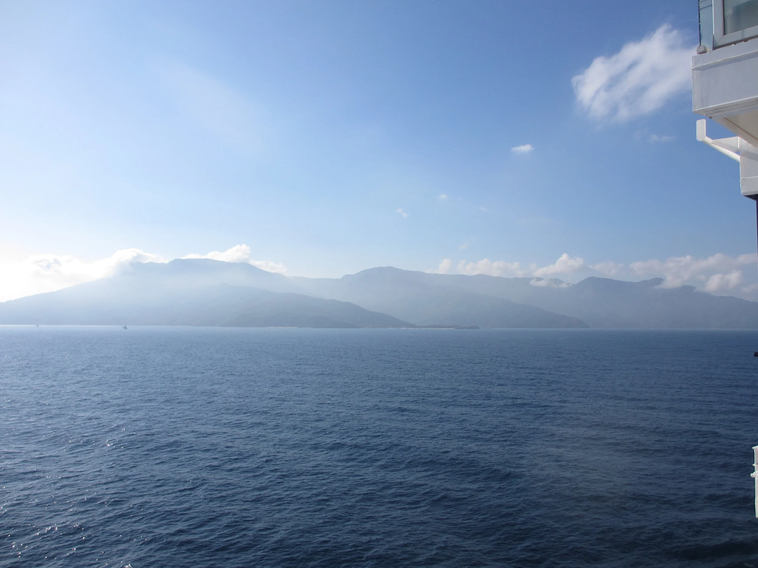 The haze of the sun as the ships approaches, creates a dreamy landscape
