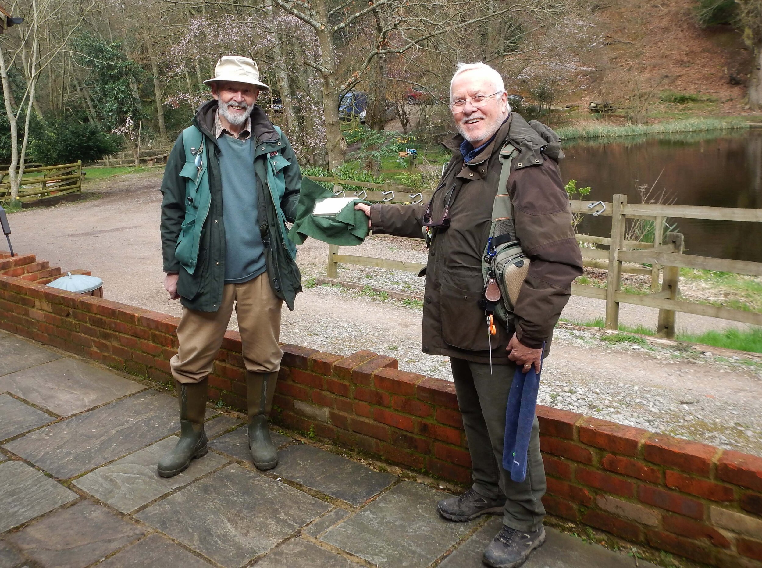 Alan presenting Monk Trophy to  George at arms length 