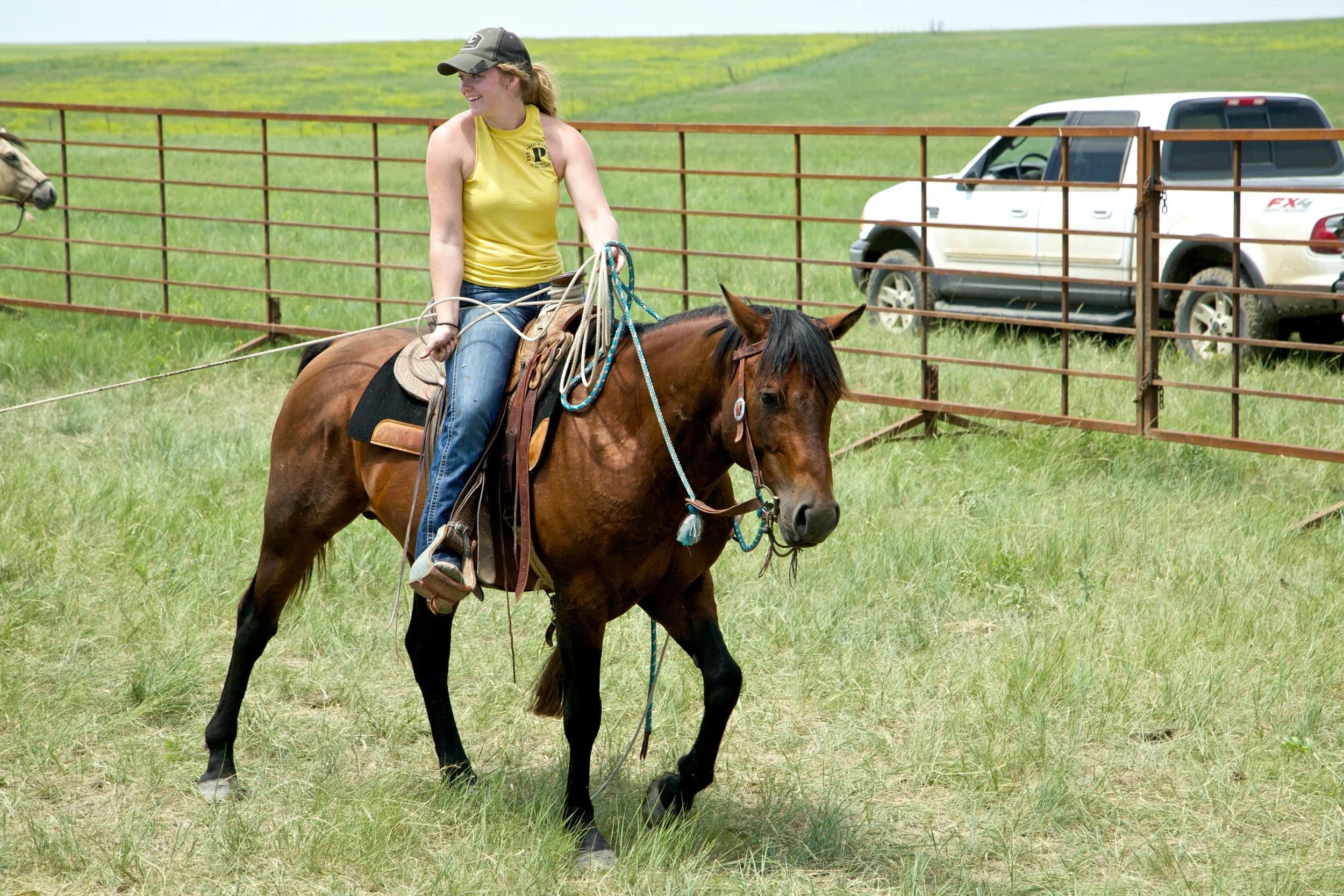 Intern Mentor, Melissa Loeschen, aces her end of the summer "final," catching two back feet of a calf and dragging him out of the branding pen. Prior to her internship, Melissa had never roped. Below is the story of how she made such progress in such little time: