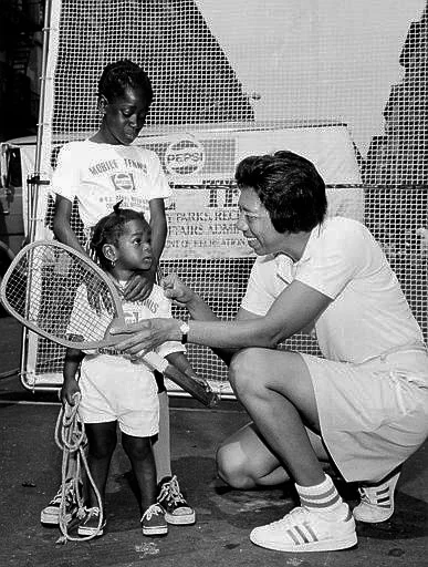 Althea Gibson shows
the first tennis racket she used in 1942 on the streets of Harlem to Tiny
Huston, 9, and her sister Monica, 1, in New York City, July 11, 1973. Gibson was born in Silver, South Carolina in 1927 and soon moved with her family to Harlem. She struggled in the classroom but excelled in sports and found her way to the Harlem River Tennis Courts in 1941. Gibson went on to win the Wimbeldon and U.S. Open championships in 1957 and 1958.