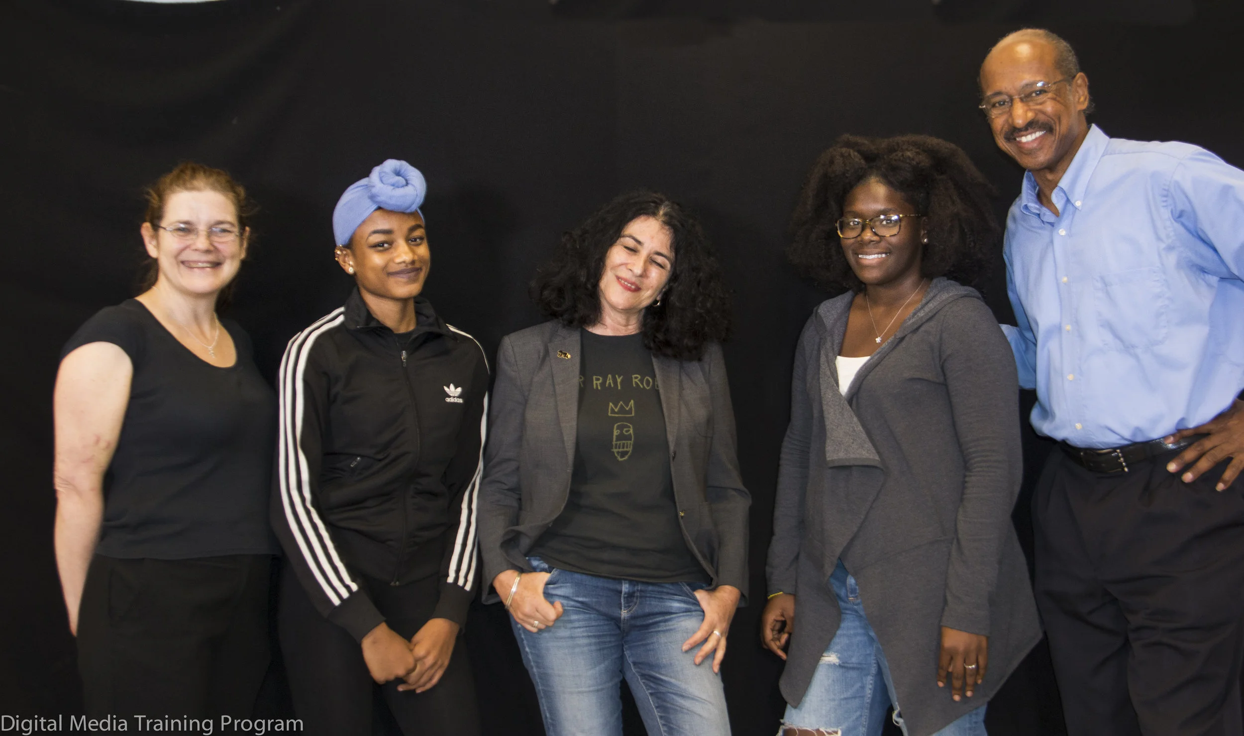 J ournalism Instructors Joann Mariani and Melvin McCray (far left and far right) assist New Explorers High School students at the conclusion of an interivew with Photographer Janette Beckman (center).