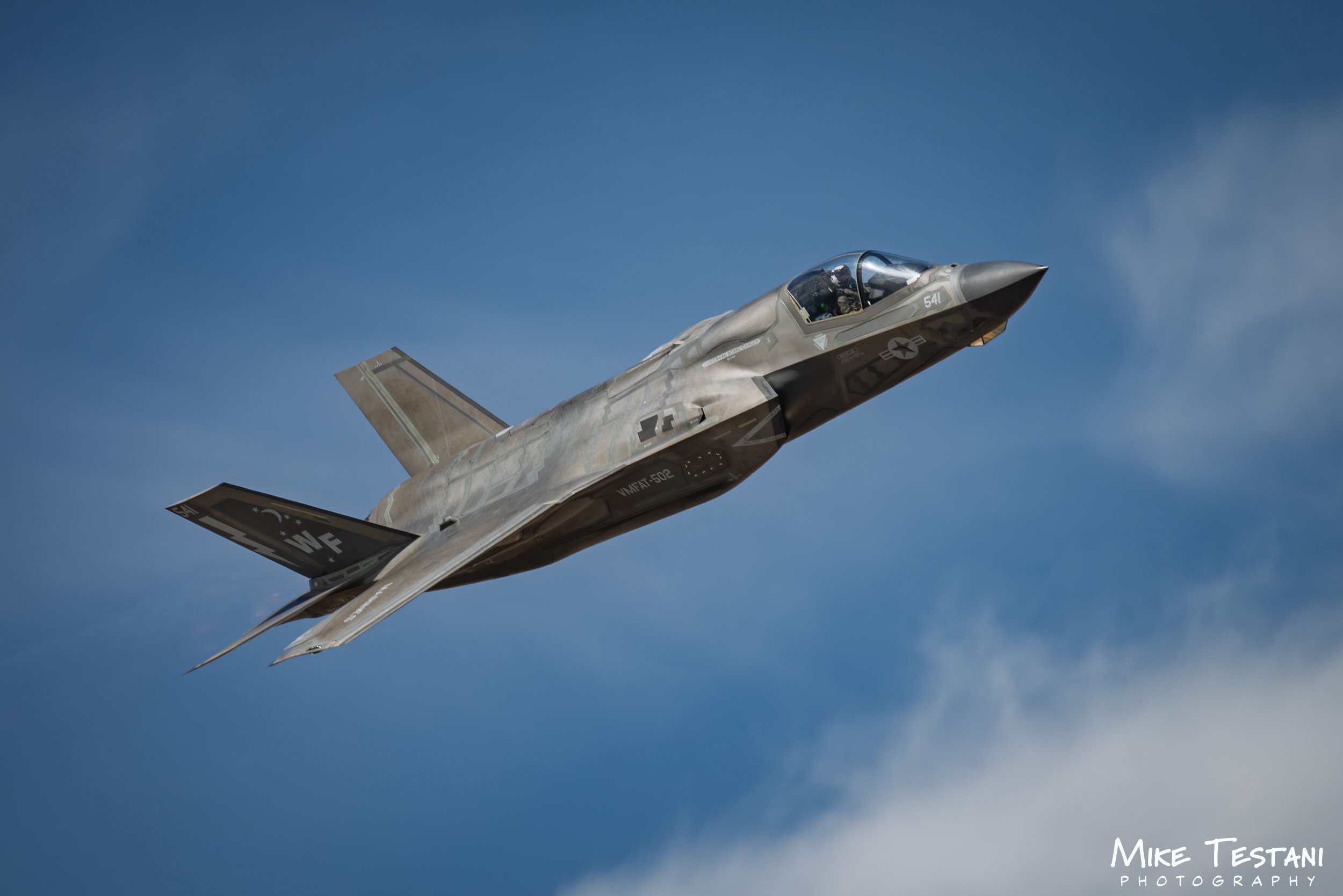Fighter jet flying in a blue sky