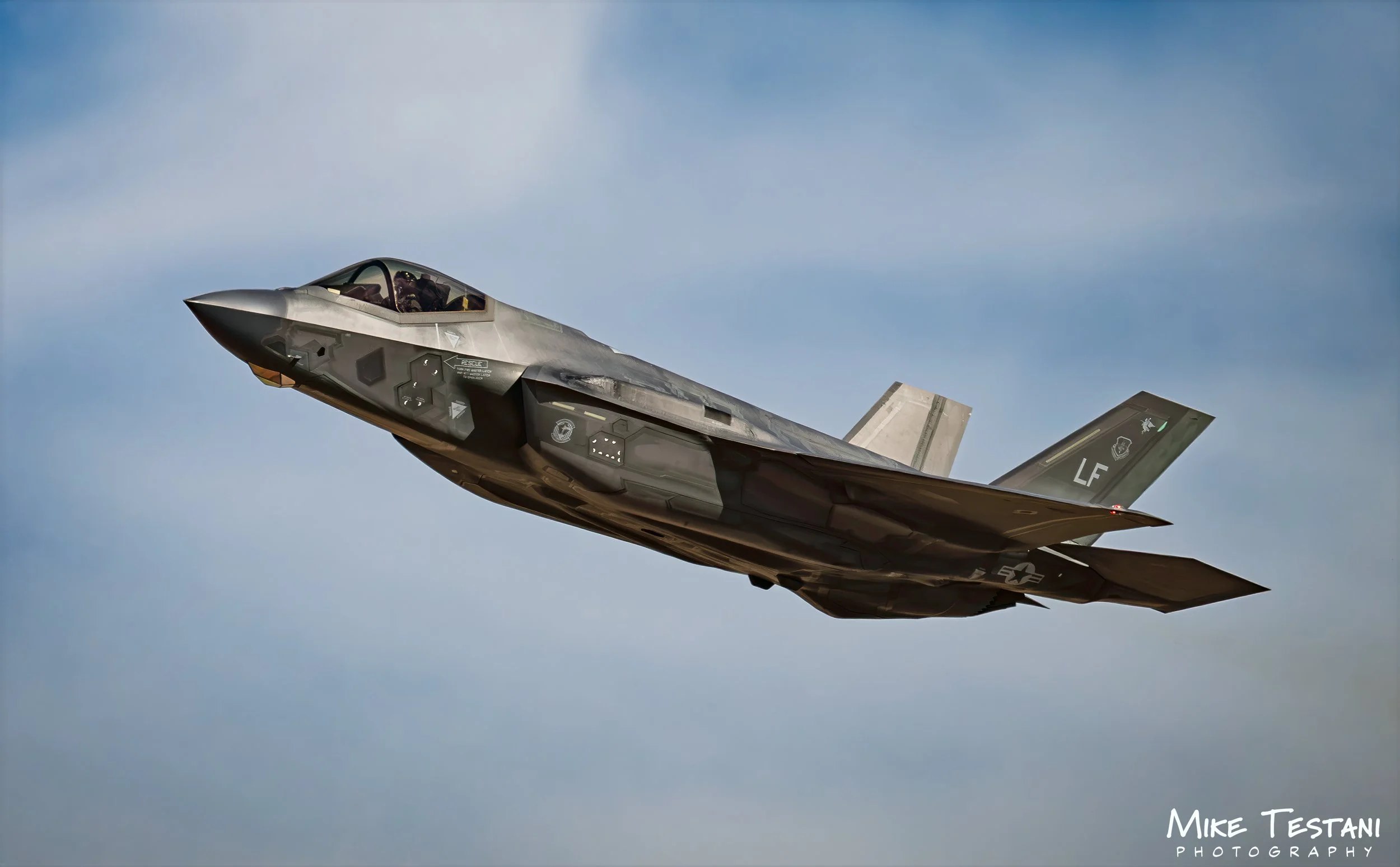 A fighter jet aircraft flying in the sky during daytime.