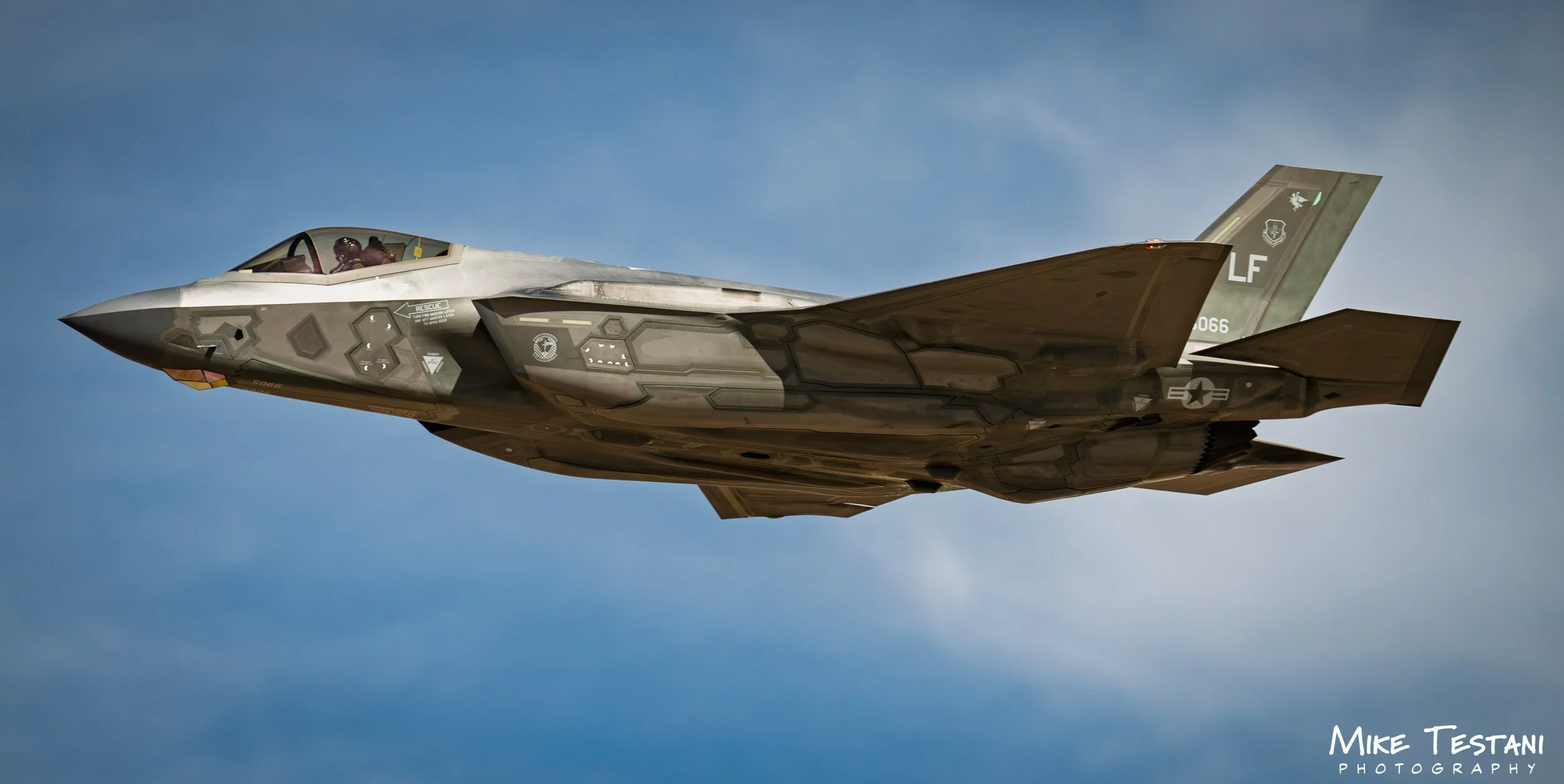 A military fighter jet flying in clear sky.