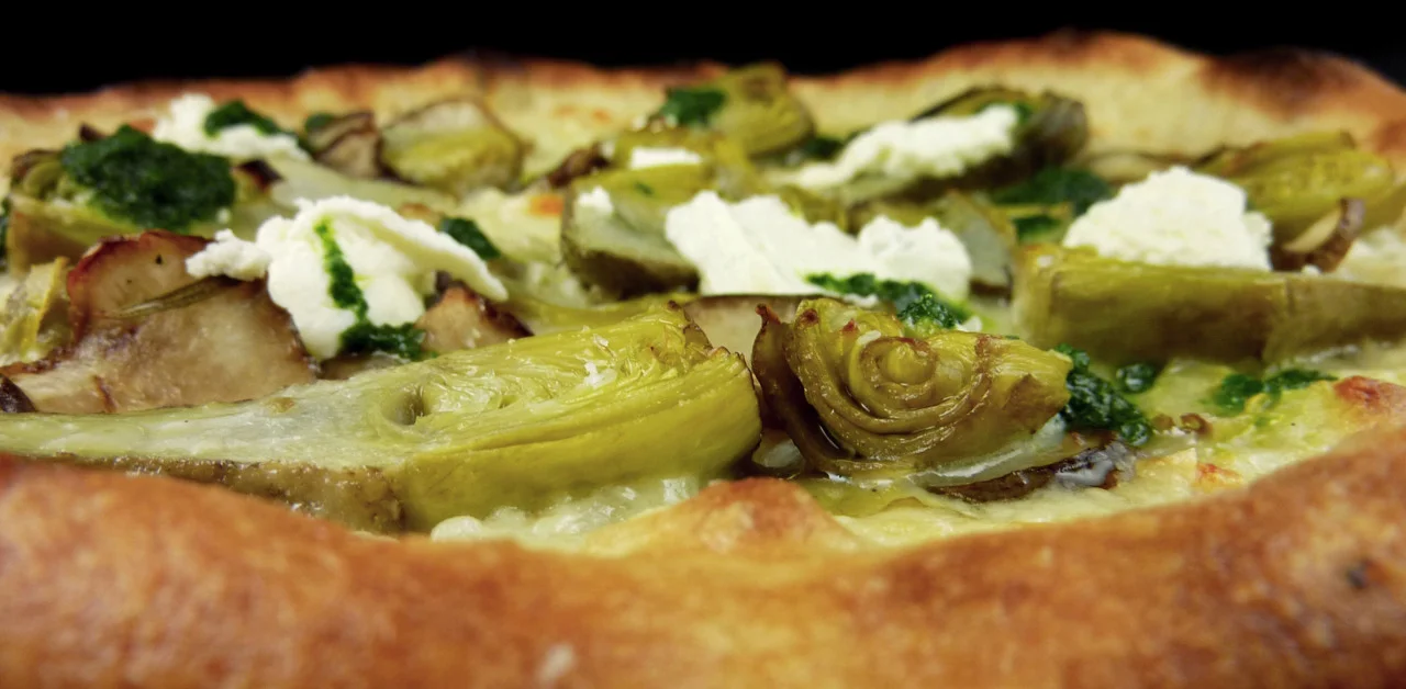 artichoke pizza biancawith shaved sunchokes, fromage blanc, &amp; preserved lemon oilClose-up.