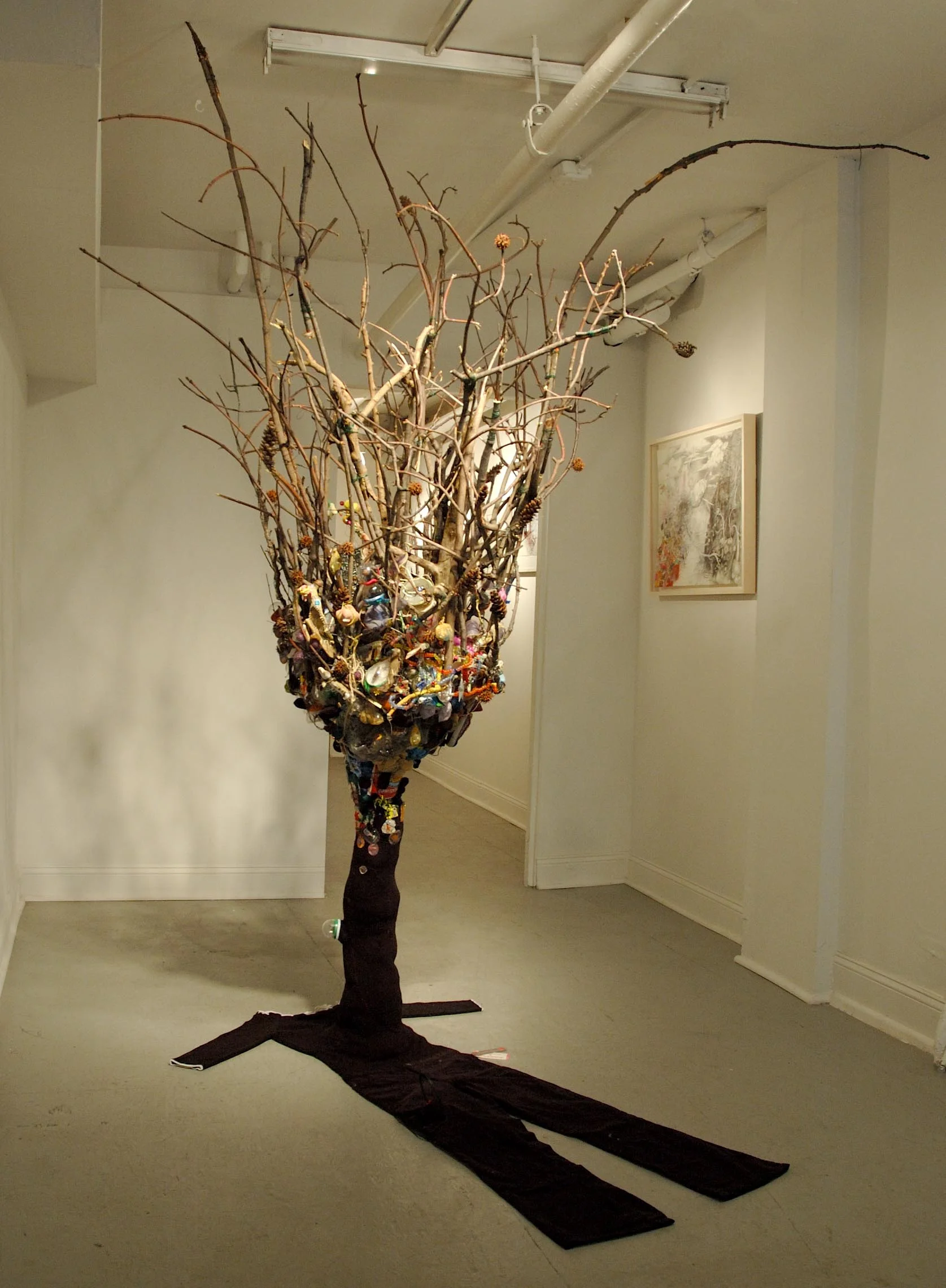 Trying Not To Die , 2009. Installed at Heskin Contemporary, NYC. Clothing, twigs, insects, trash, thread, fabric, wire. Variable Dimensions (clothing fits a 5' tall woman). 
