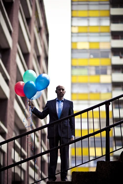 So me and Tom worked up a few different feels, as he needed to refresh his public profile and press shots. What better way then to confuse matters by having the DJ and producer weirdly gripping onto some balloons to illustrate his partying credentials, in his wedding suit, standing over you in the rain. Listen to his music, it'll all make sense; The Dark Energy Radio Show .