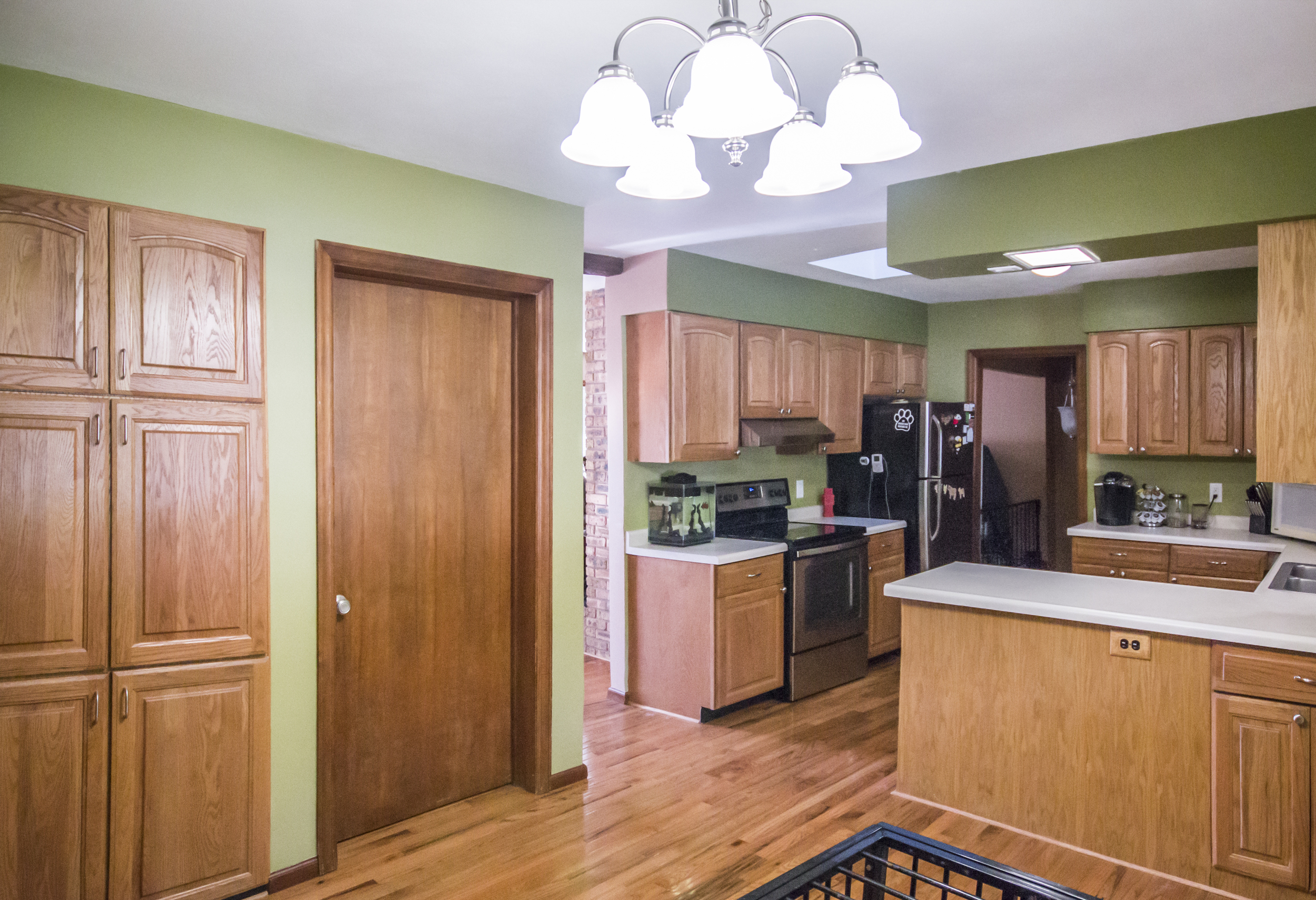 Changed: Green paint (darker green above cabinets), new lighting fixture, new knob for laundry room door. 