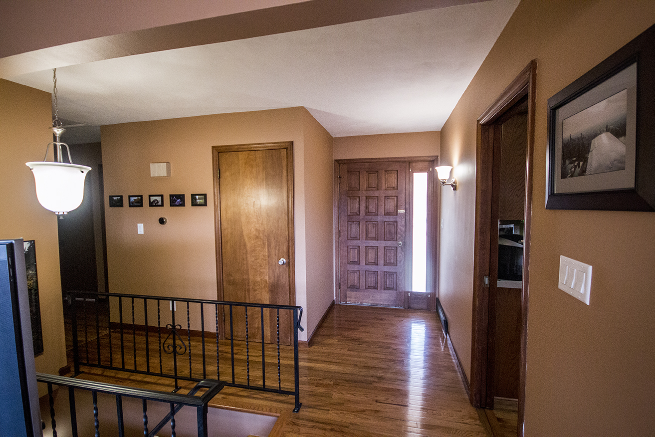 Changed: Light brown wall color, entry way light updated to match style of light above stairs, artwork on walls, removed curtain from front door window and put on a layer of spray-on frost, changed doorknob of coat closet, new light switch panels, installed Nest thermostat, removed rug.