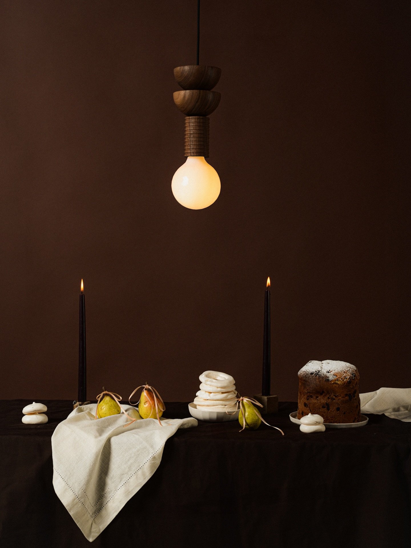 Quiet celebrations unfold around the table.
Our Junit lamp in walnut casts a warm, steady glow, anchoring this scene with sculptural clarity and calm presence. Light becomes atmosphere, form becomes gesture.

Our shop remains open today and tomorrow 
