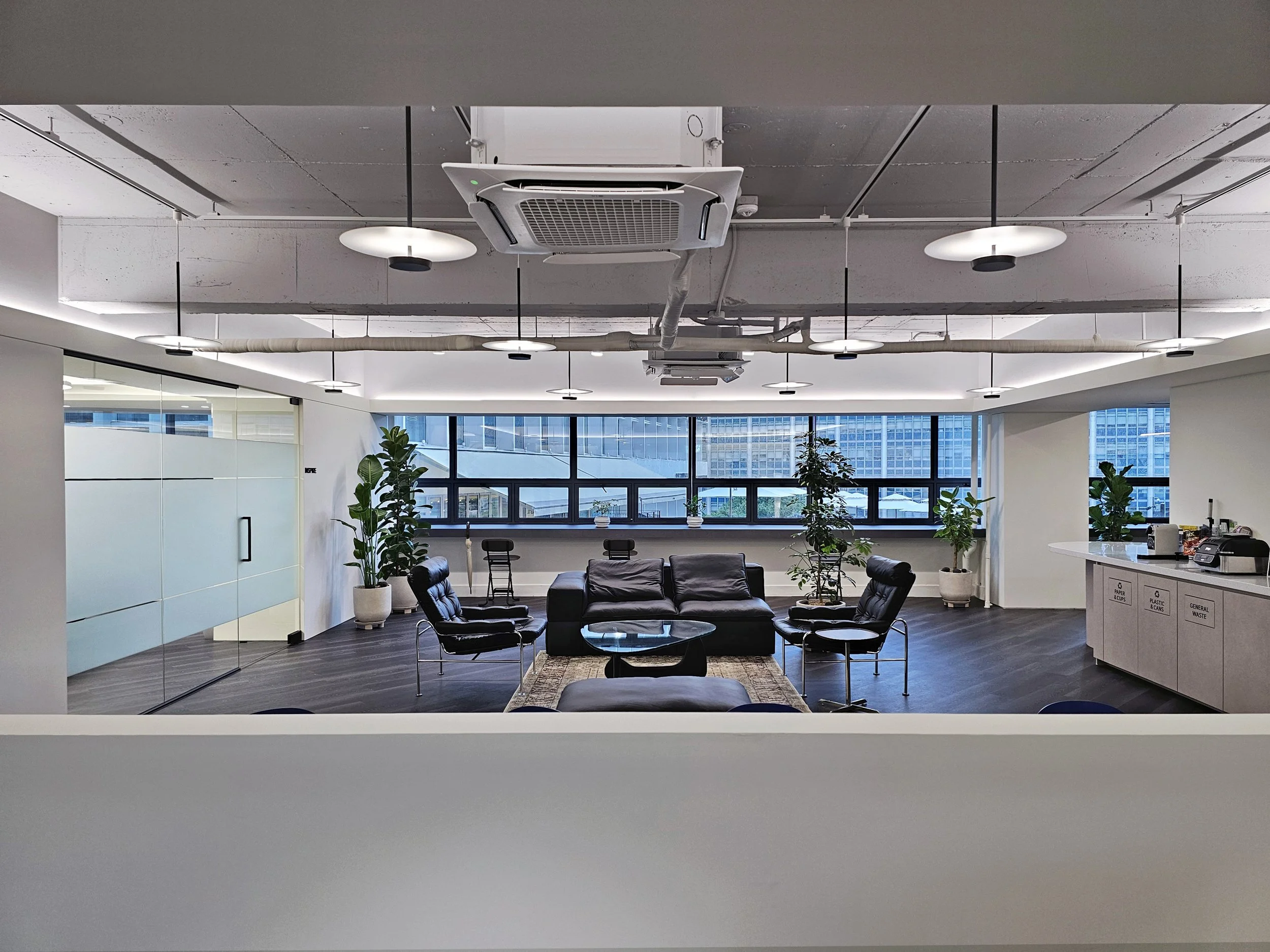 Modern, industrial chic lounge area as seen from the office entrance