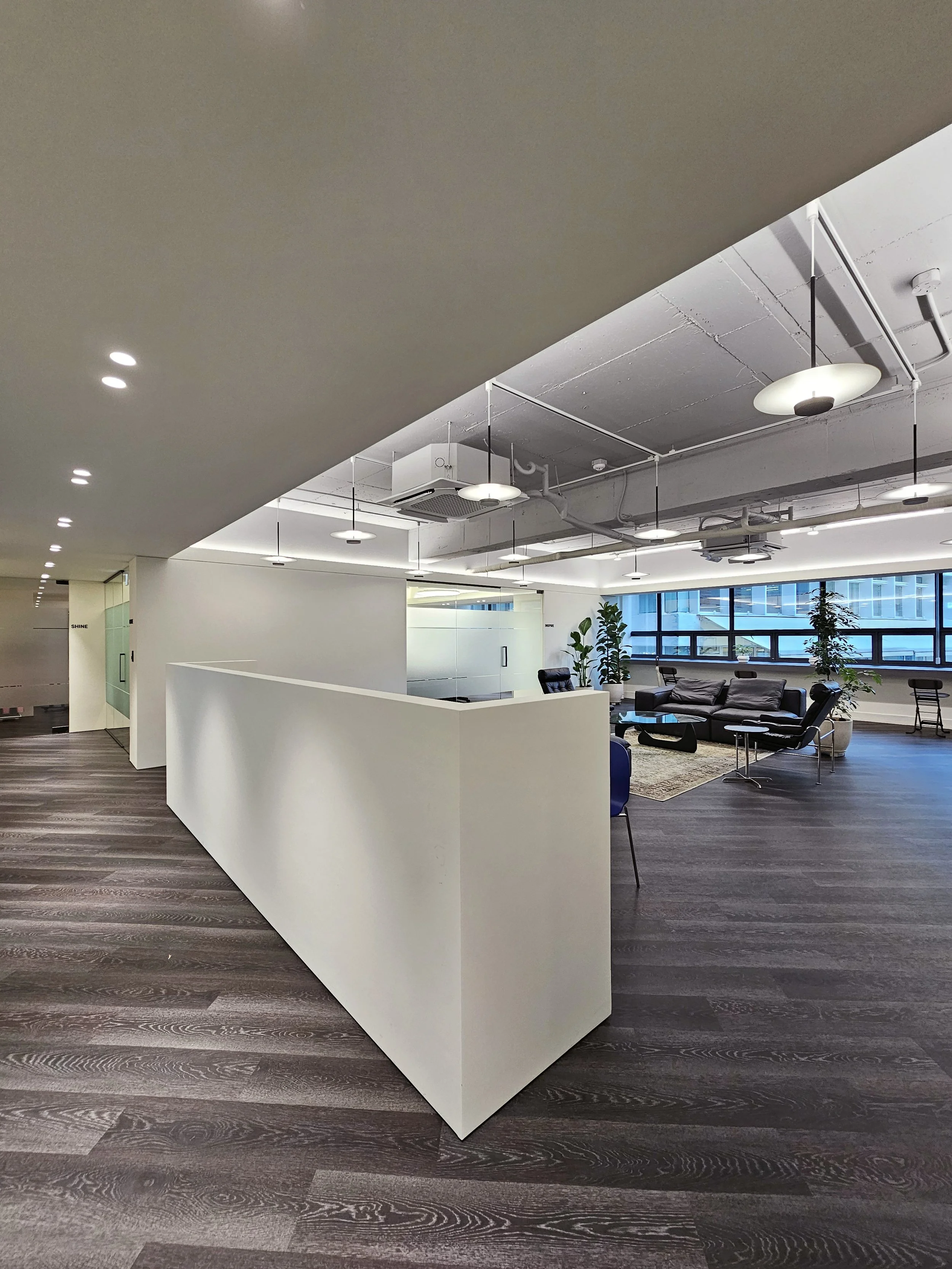 Quarter view of the conference room area from the entry corridor with the fixed bench seating in the foreground