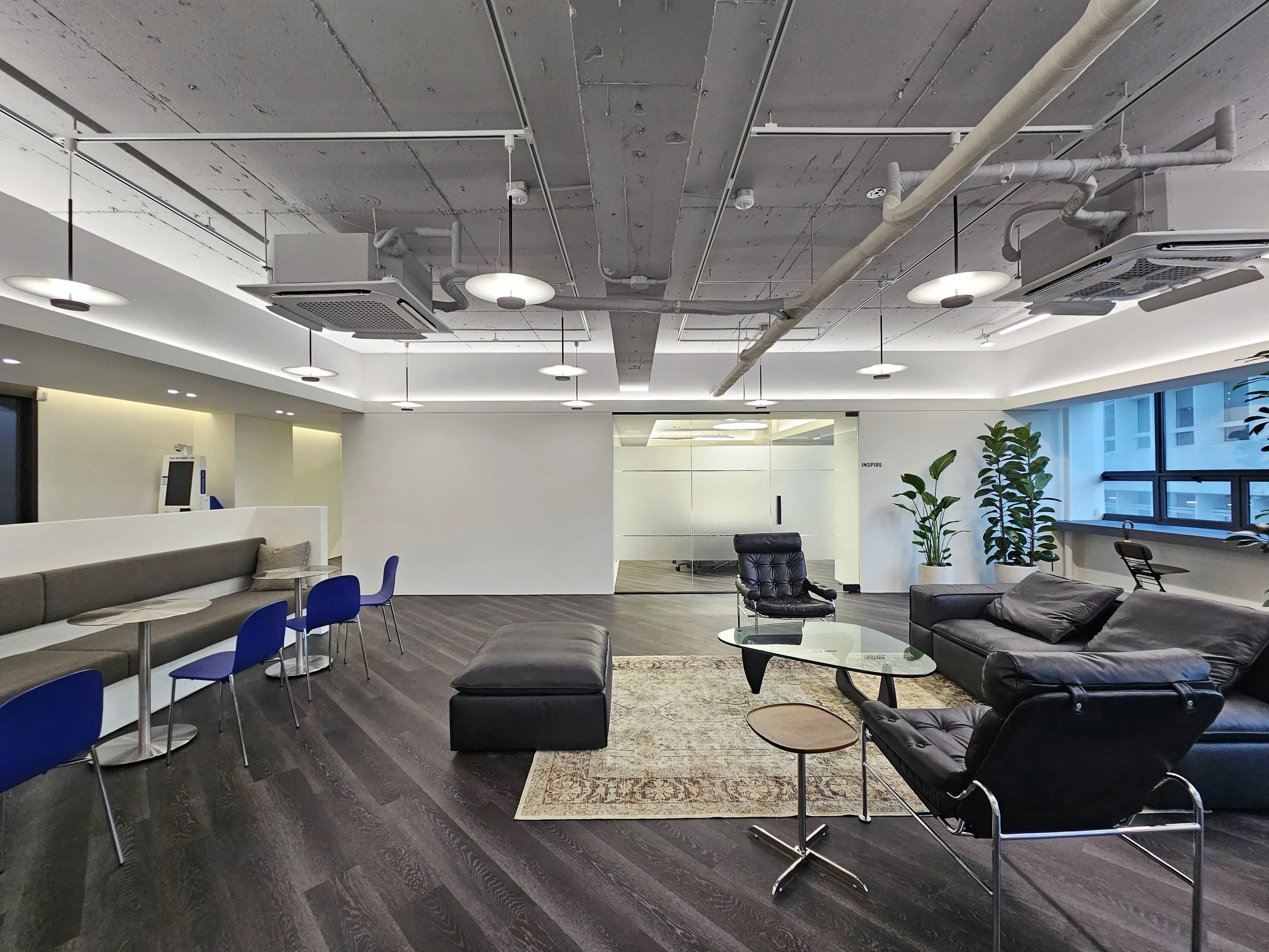 VIew of the  office lounge with the main conference room in the background