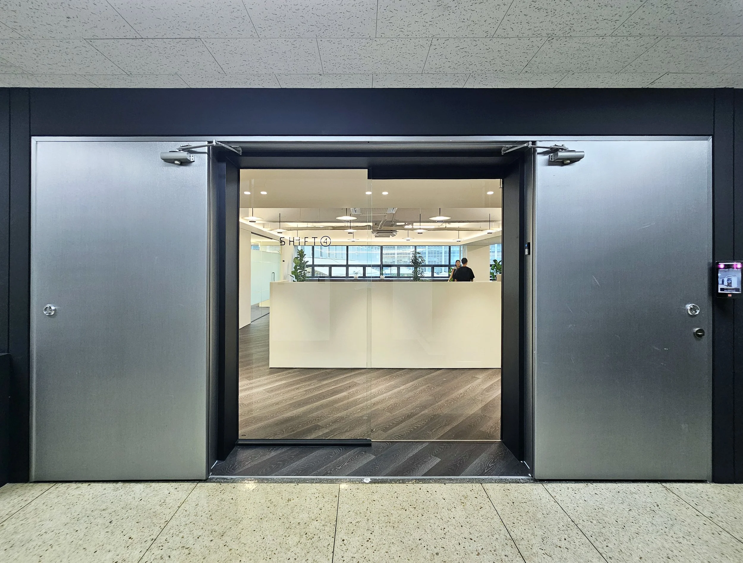 View of the office entrance and beyond from the elevator landing