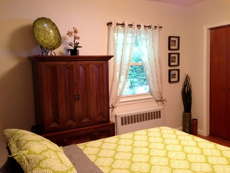 Instead, install tie-backs like these branch pulls to create a nice shape at the window area and now the radiator attracts less focus. The off-white hue with ivy detailing on these panels compliments the room and goes well with the new wall color.