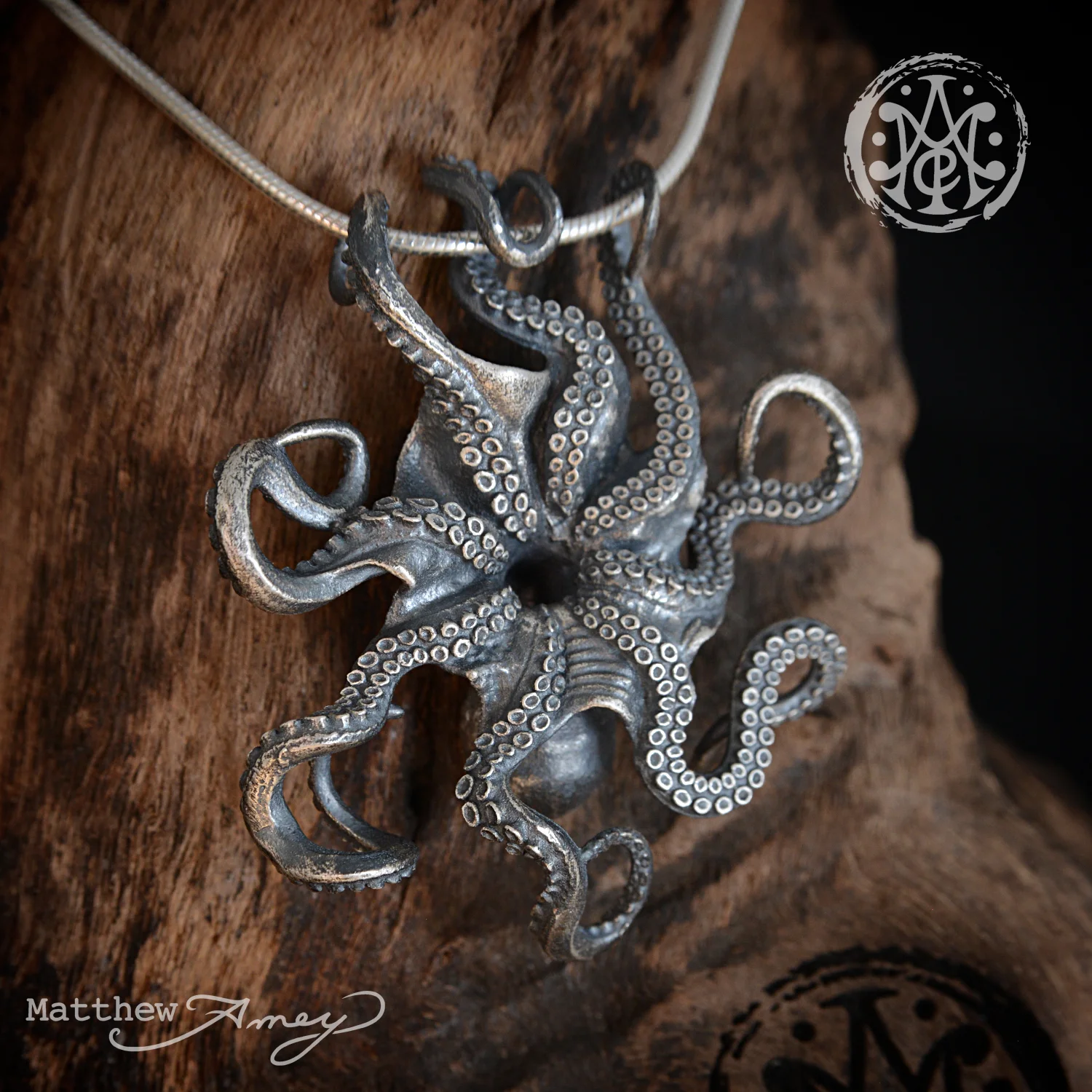 Octopus pendant in sterling silver. —
