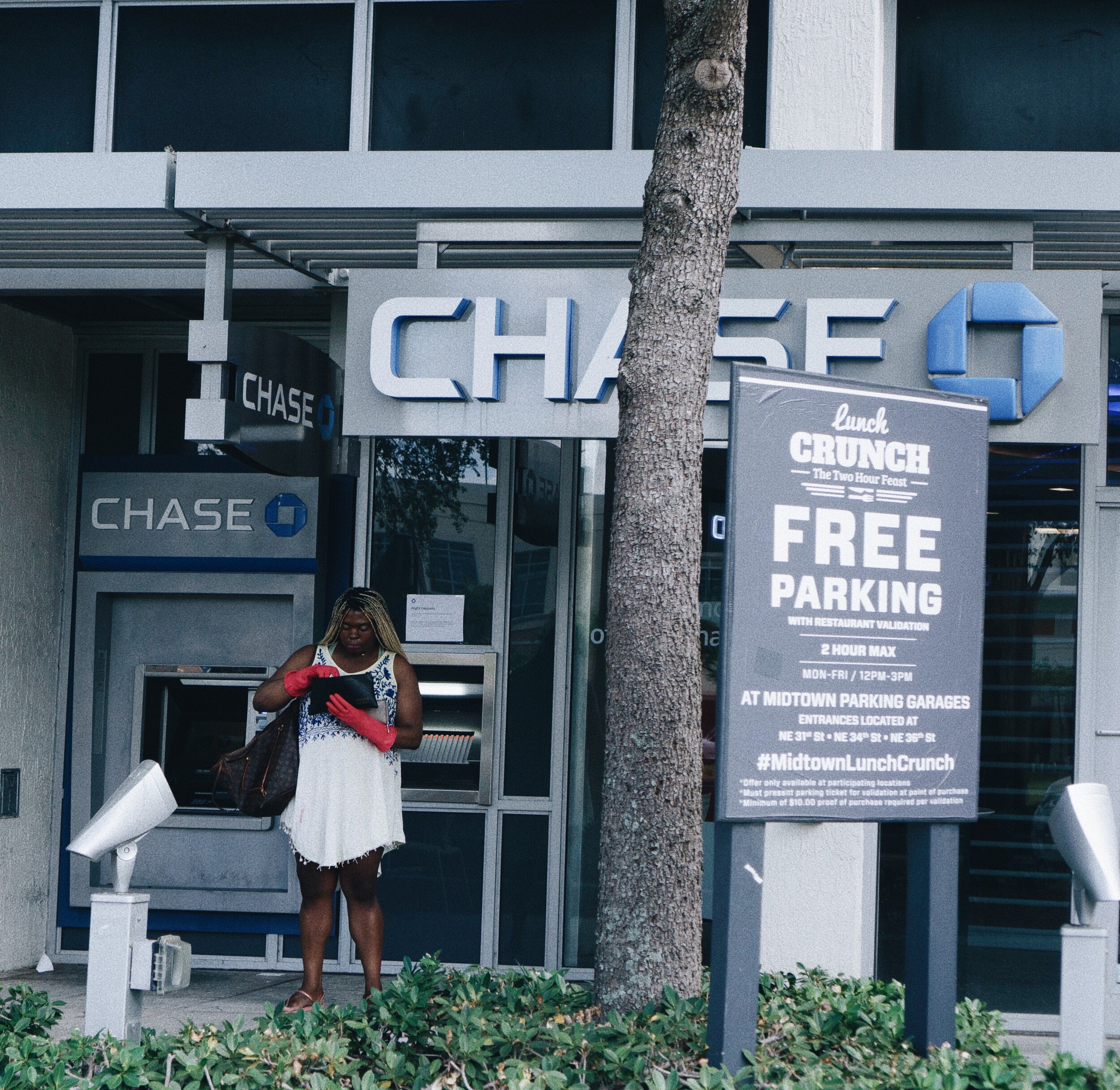 Woman taking out cash in Midtown Miami. March 22, 2020