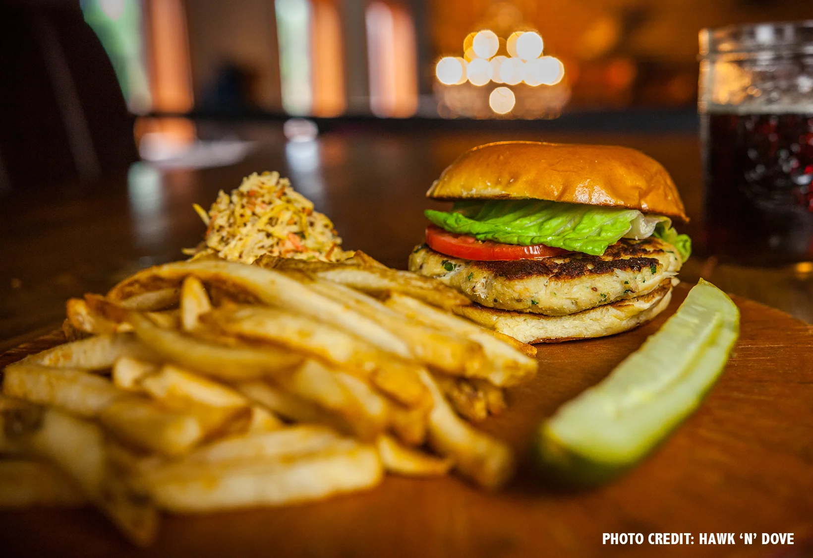 The crab cake sandwich is served with root vegetable slaw and lemon caper aioli.