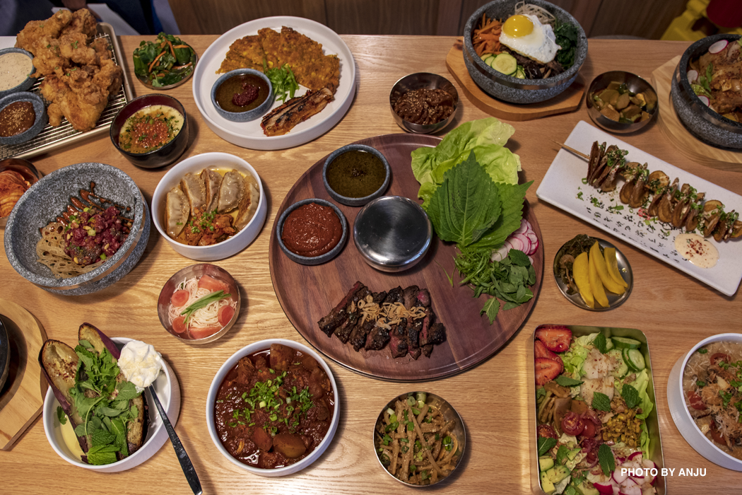A sample of Anju’s menu which includes a Ssam Board with seared beef ribs, Dosirak Salad with strawberries and avocado, and Mandu, pork and kimchi dumplings.