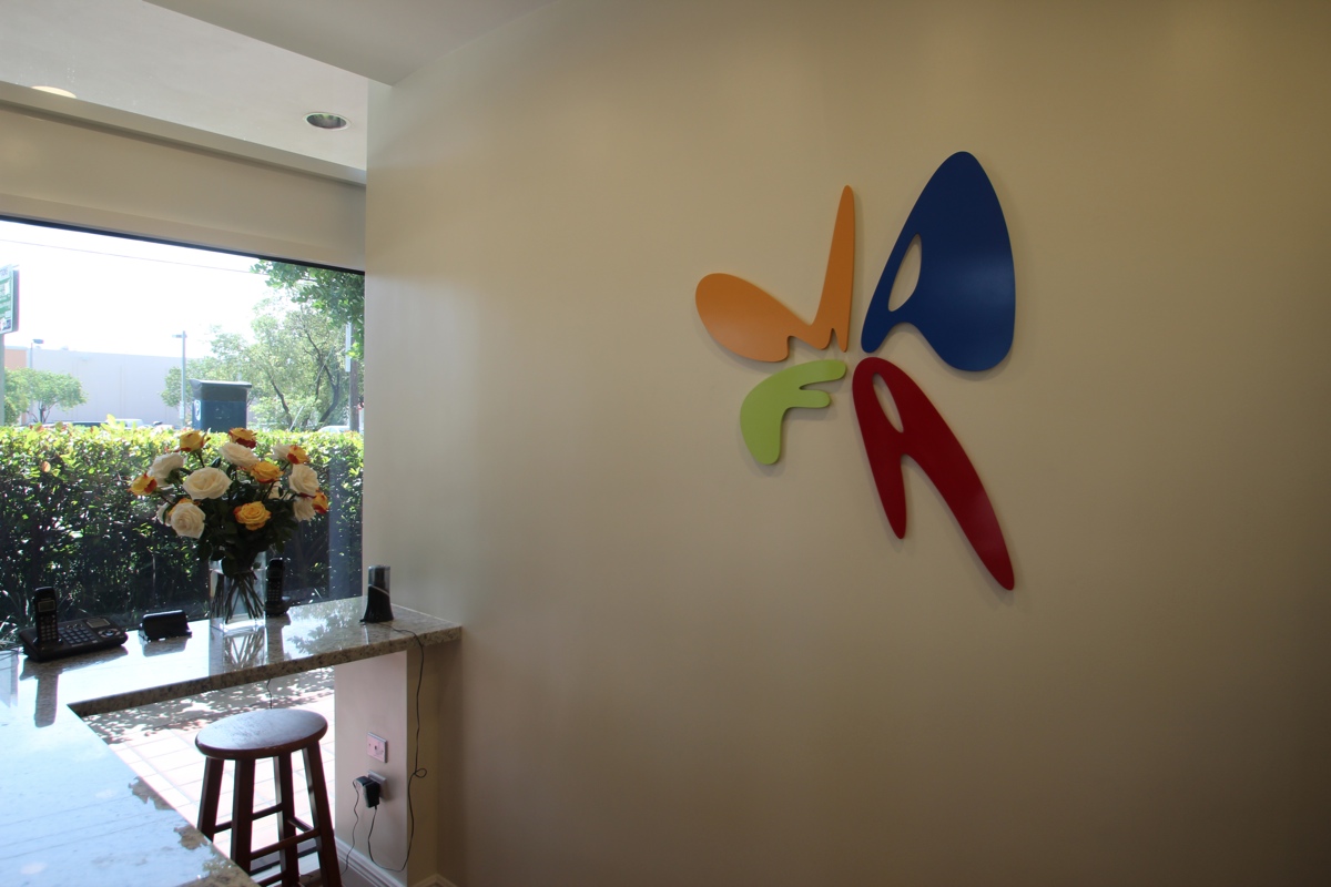 OUR COLORFUL LOGO WELCOMES YOU IN THE LOBBY