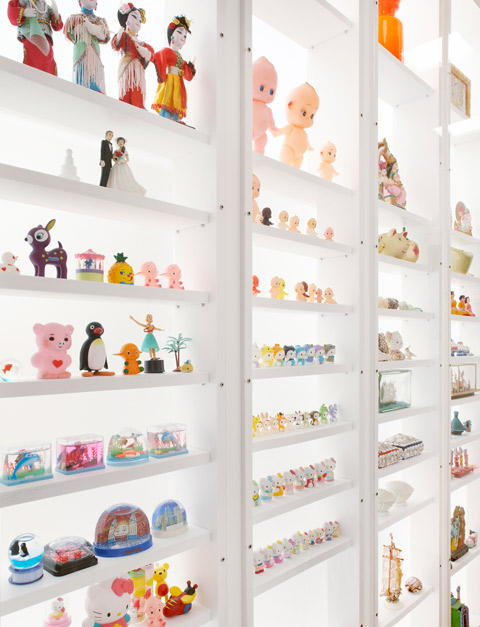 A stunning floor to ceiling cabinet is lit naturally by a skylight. Each member of the family has placed a selection of their favourite trinkets and collectables on each of the shelves.