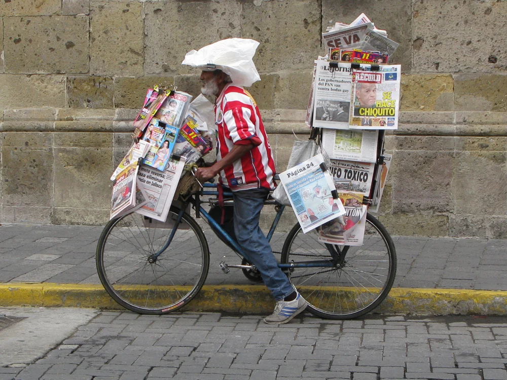 NewspaperBikeSeller-EBree_MGM.JPG