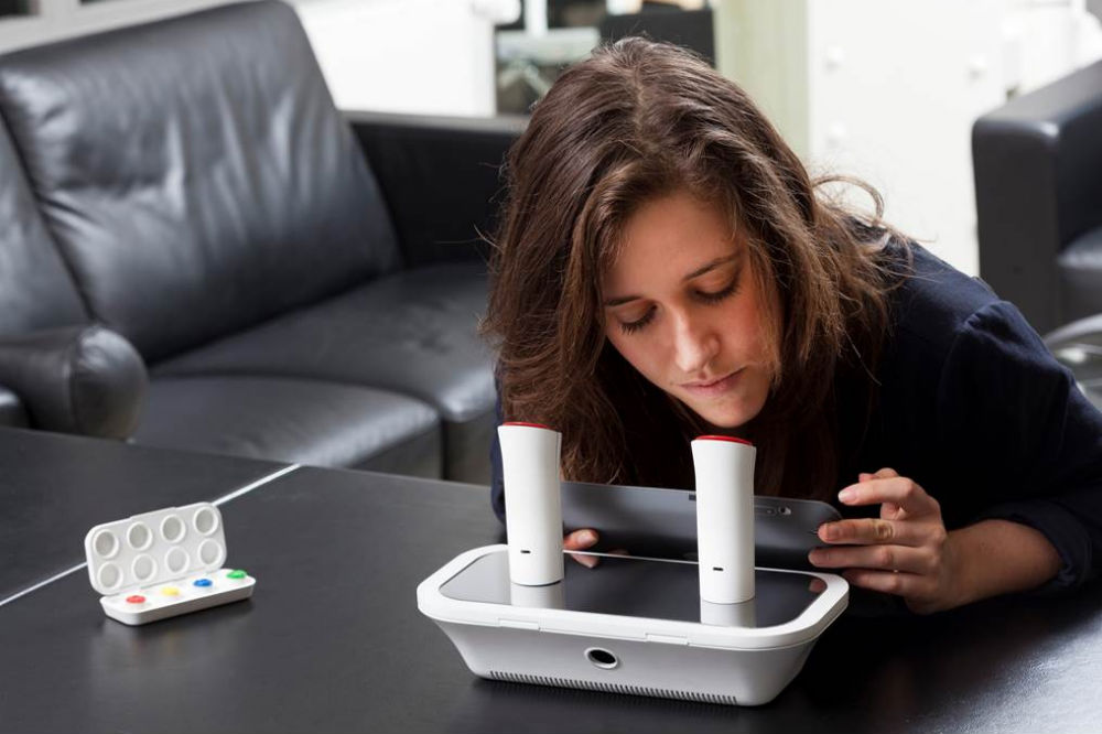 Rachel Field demonstrates the oPhone. Image from Wired, where you can read more about the oPhone here .