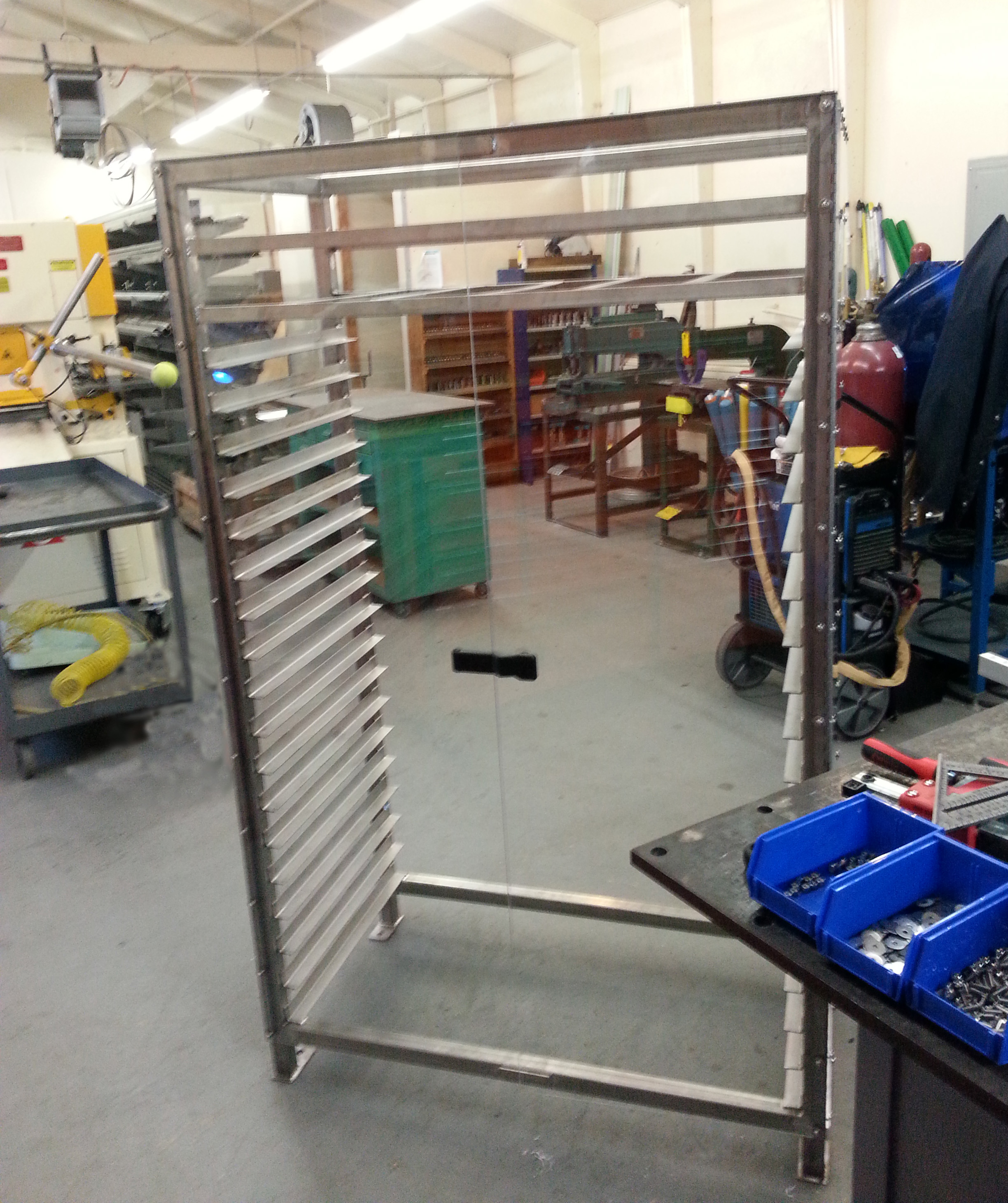 One of three custom Stainless Steel Food Production Cabinets. These cabinets are designed to hold 1050 pounds each. It's hard to see the Acrylic sheathing in this photo it's so clear.