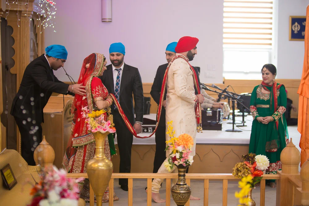 It is to symbolize that the altar, or the officiant, or the Guru, is at the center of the marriage.
