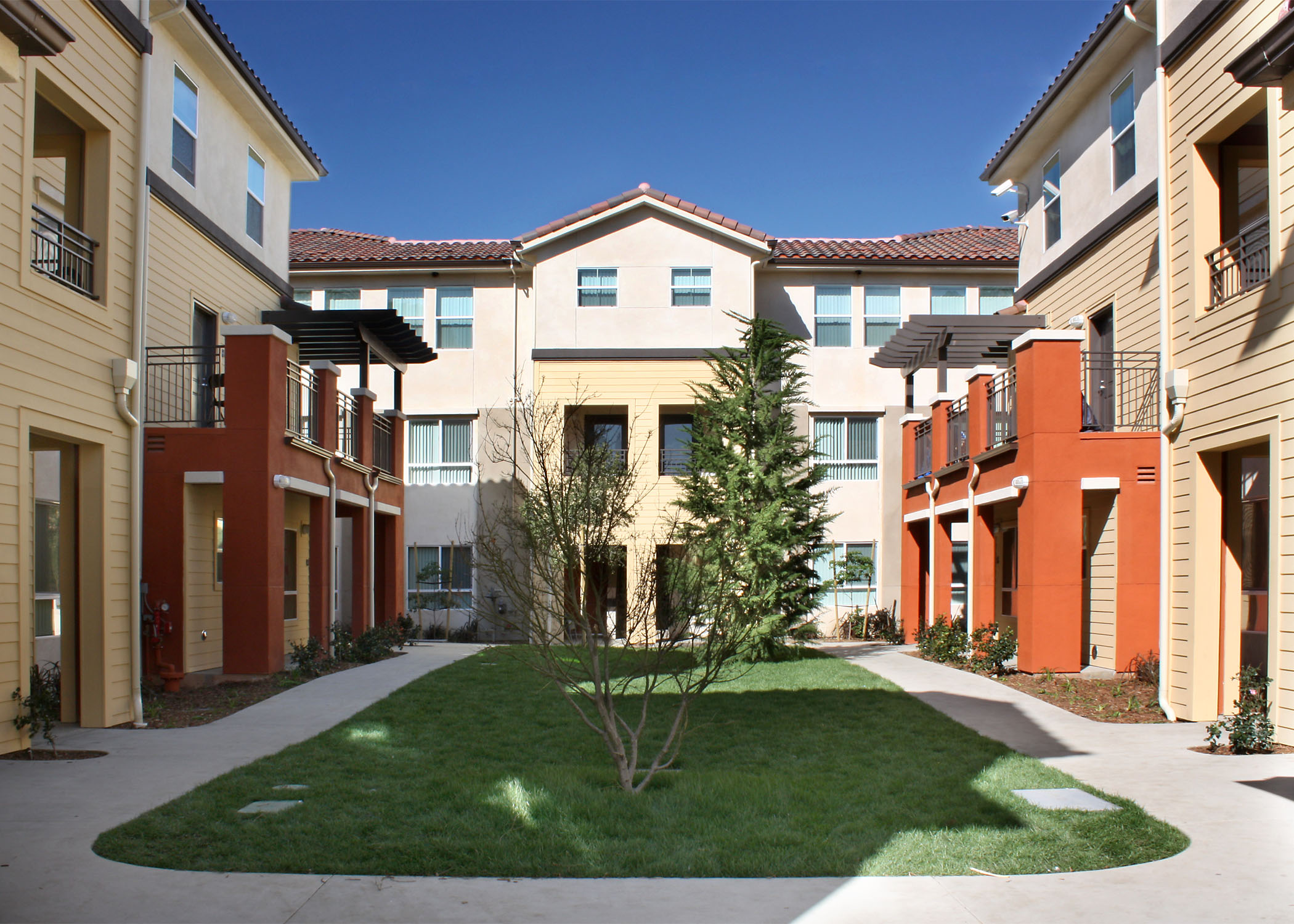 The Family Commons at Cabrillo adds 81 dwelling units to accommodate the needs of formerly homeless families within the largest, most comprehensive residential and social service complex of its kind in the country. The project aims to provide families with a higher sense of independence and self-sufficiency within a service-enriched setting. Located within the context of a 26 acre campus dedicated to the benefit of the homeless, the project brings to fruition our continuum of housing for families, ranging from emergency shelter, transitional housing, and now permanent affordable housing. The project specifically targets homeless families with a mentally disabled family member and benefits from nearly $1.0 million in annual service funding and rent subsidy to support the population. 