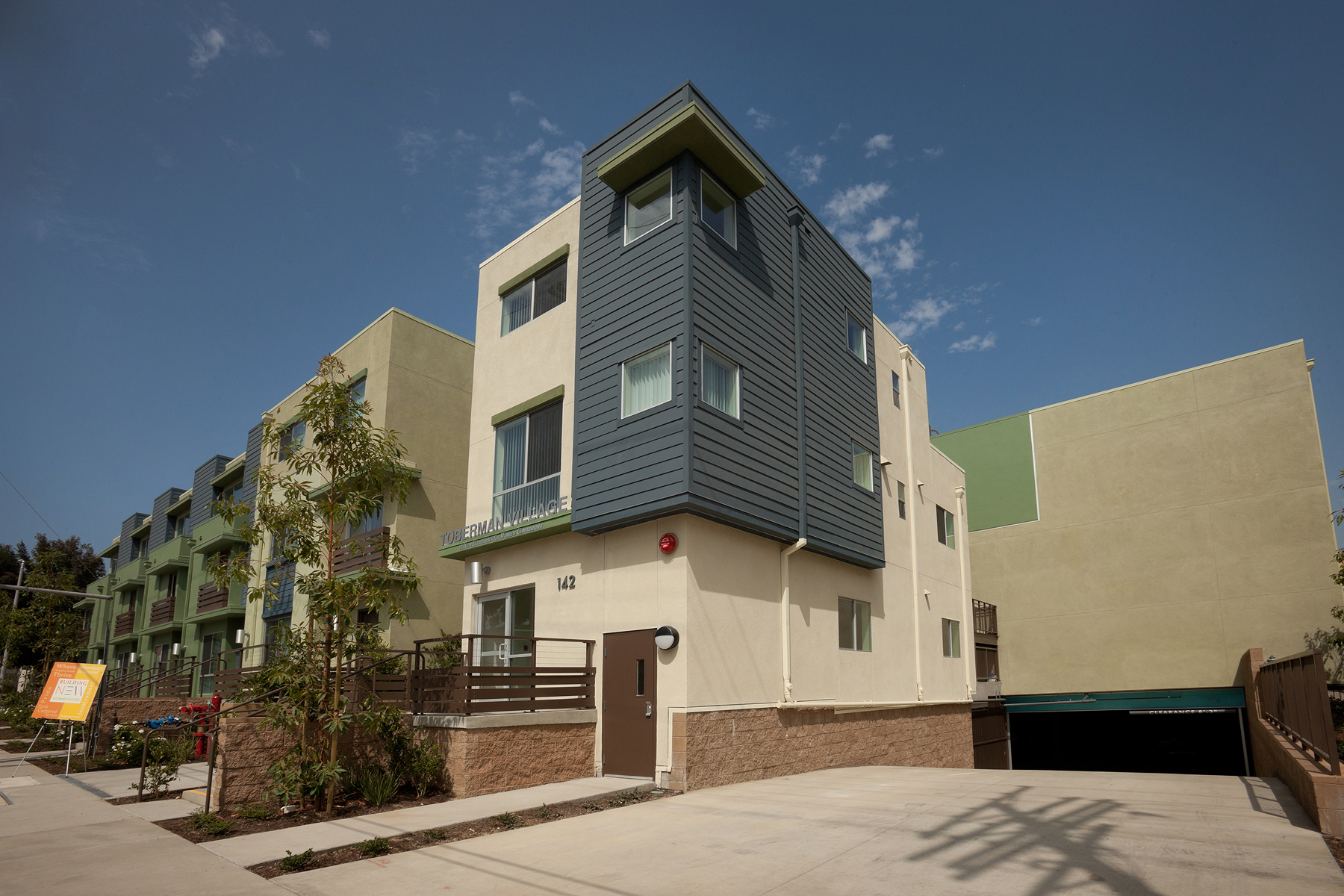 Toberman Village is situated below a bluff in a site that is predominately flat and is 2 blocks away from the Los Angeles Harbor (the Pacific Ocean). Toberman Village is California Tax Credit project that is composed of 49 units which vary from 3 story ‘walk-up’ town homes to 1 story flats. The units are geared towards large families and range in size from 700 sf 1 bedrooms to 1400 sf. 3 bedrooms. Five 3-story ‘walk-up’ townhomes fronts Santa Cruz St. to promote ‘eyes & ears on the street’ for safety and to enhance the streetscape which maintains its residential character.