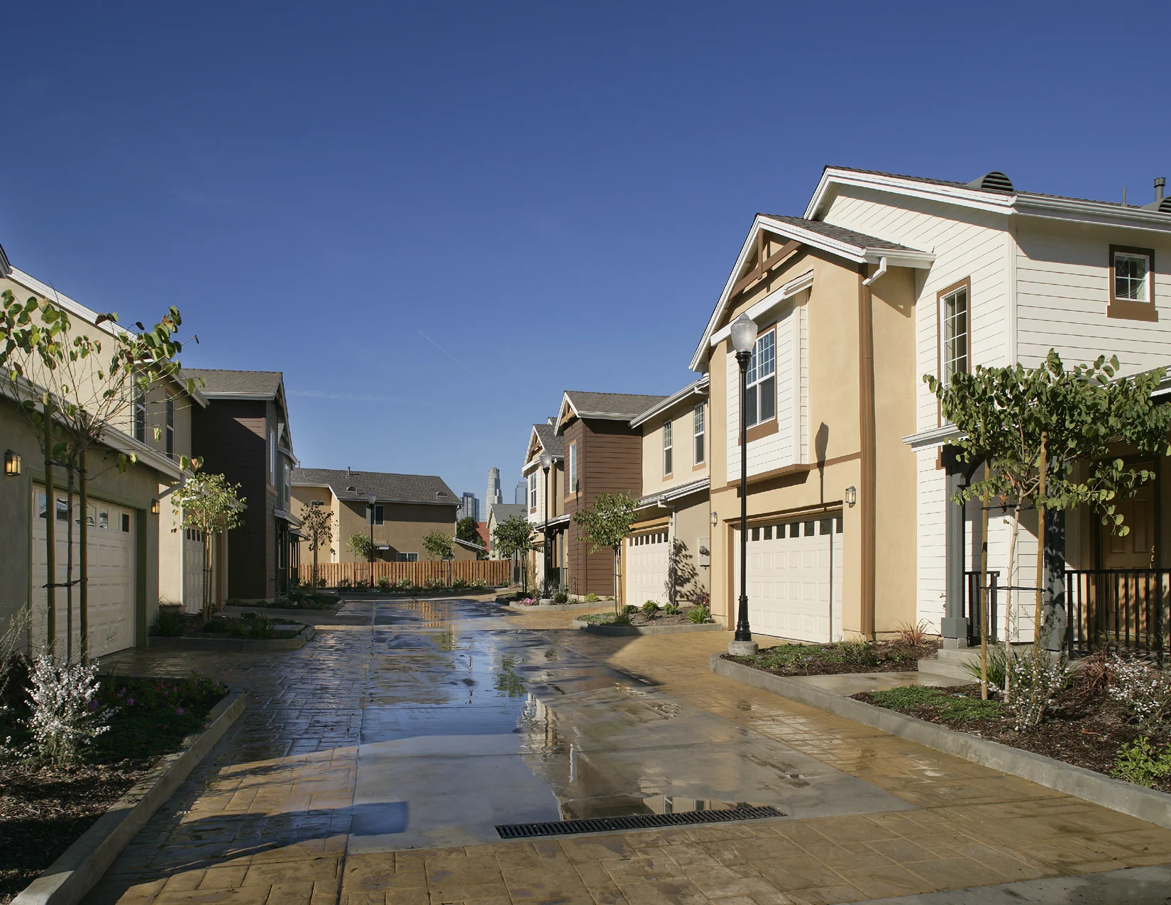 Las Casitas creates a neighborhood with detached single-family homes that enhance the community, as well as give its residents pride in ownership. The majority of the single family homes are clustered off of private motor courtyards/driveways to maximize private outdoor areas. These motor courtyards/driveways also serve as private community play areas for the residents. The homes are designed to reflect the folk Victorian architecture that is prevalent in this neighborhood