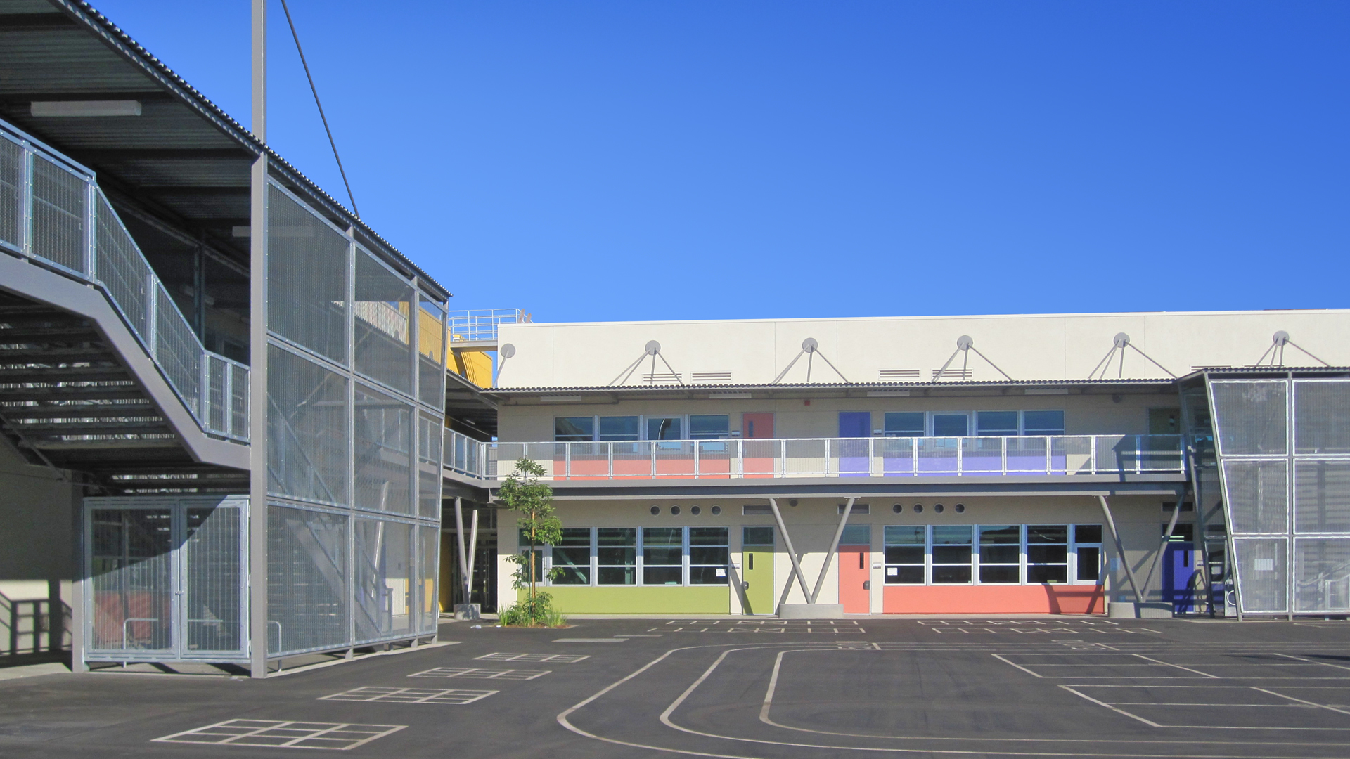 Buildings are limited to two stories to be compatible with the adjacent residential neighborhood and provide as low of a profile as possible for the children. Additionally, each grade is clustered into a series of “pavilions” to further deinstitutionalize the scale and form of the school. 
