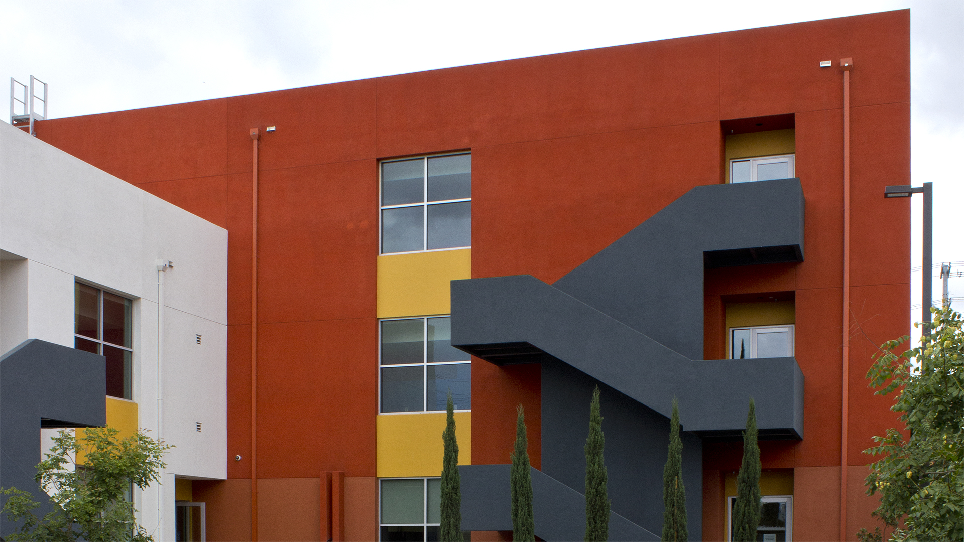 The Pacoima Entrepreneur & Training Center is located in an economic development zone within the greater Los Angeles metropolitan area. The project is intended to revitalize the community by providing training for small business owners and adding jobs to the local economy. The commercial office building is 14,000 square feet on 3 levels, with large open space offices on each floor. Floor-to-ceiling-glass on the first level adds visibility at the pedestrian/street level. The third floor is stepped back from the street to reduce the massing and to provide exterior space on the upper level. 