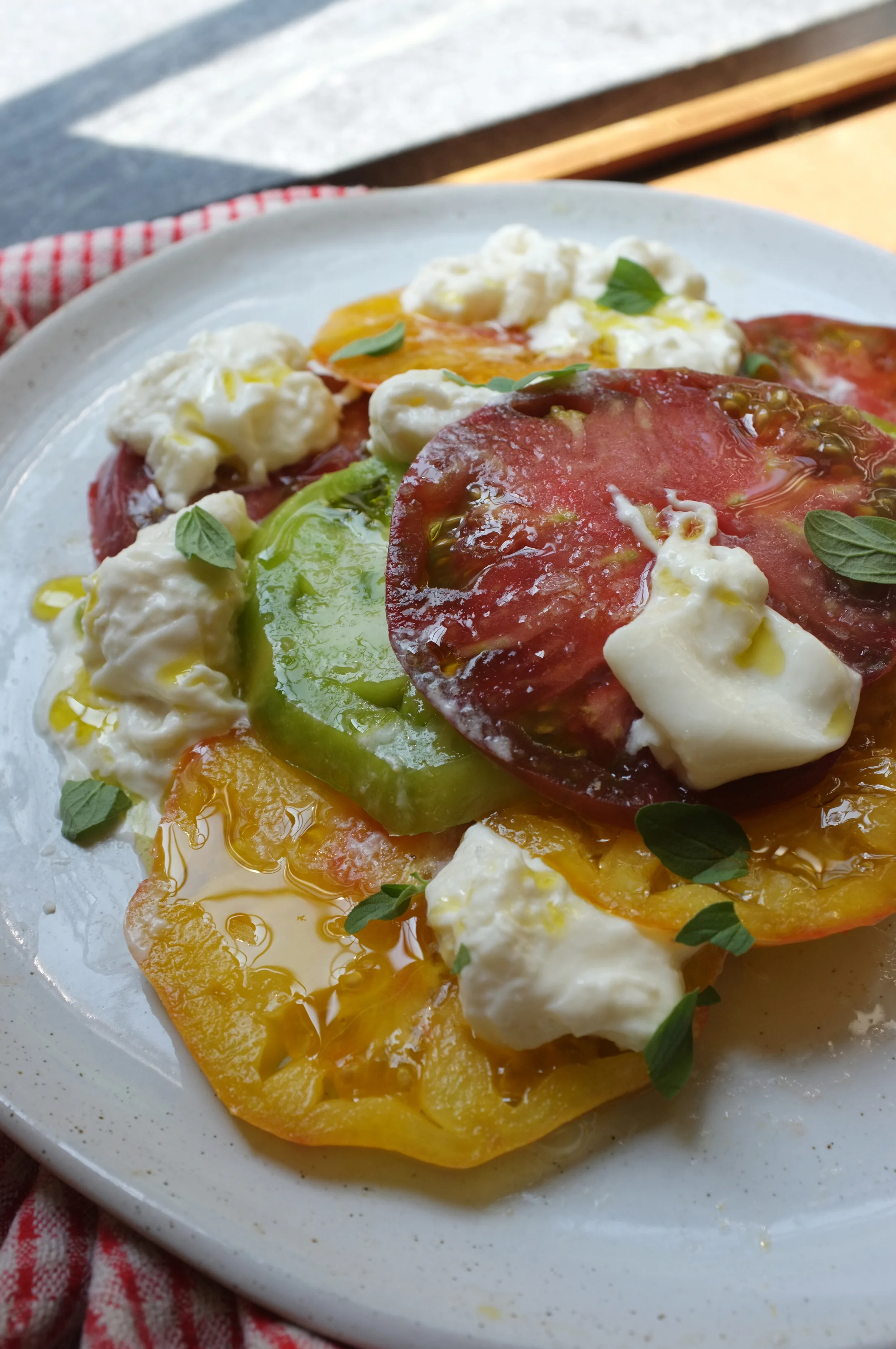 Fresh heirloom tomatoes with burrata, olive oil, oregano and Maldon salt.