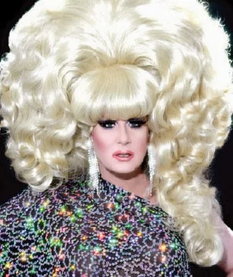 Try getting that hair into a normal taxi. Lady Bunny, from here .