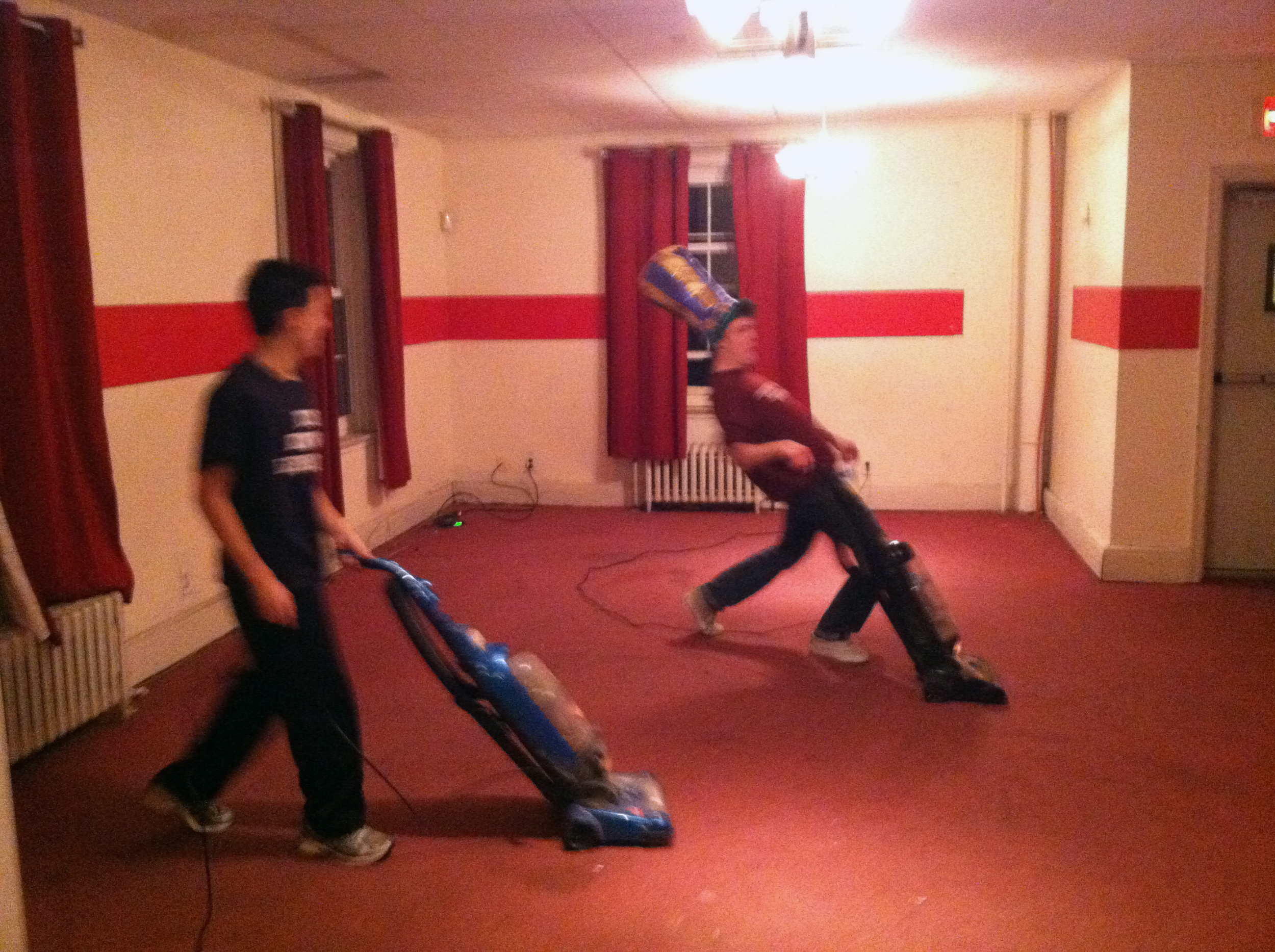  2013 Alumni Work Weekend - Pool Room Project Matt Liu (L) and Zach Kramer vacuum the New Carpet 