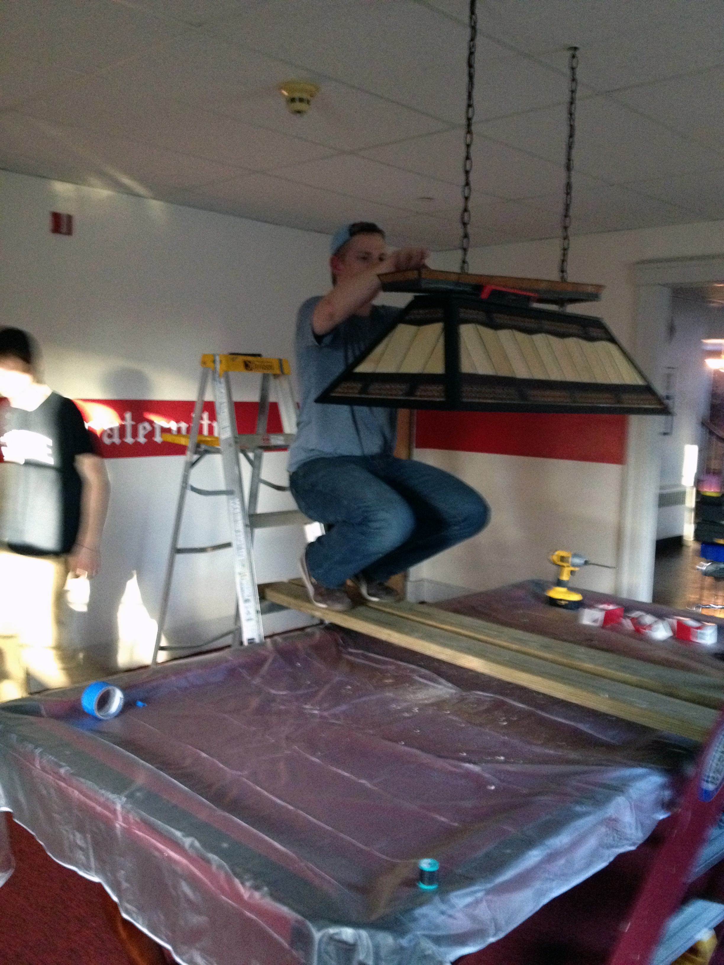  2013 Alumni Work Weekend - Pool Room Project Kevin Trippel installs the new pool light 