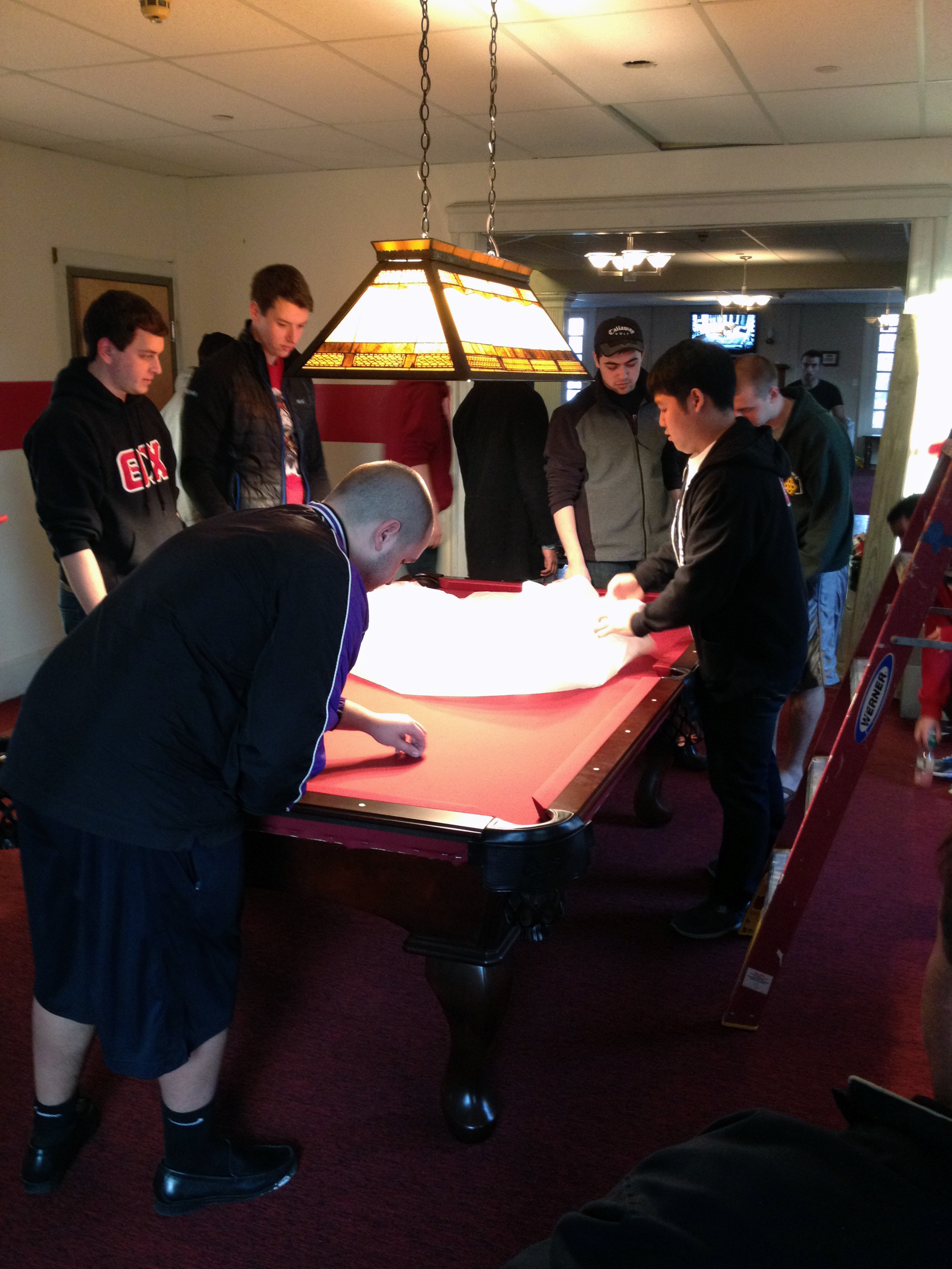  2013 Alumni Work Weekend - Pool Room Project cleaning the table before the first game 