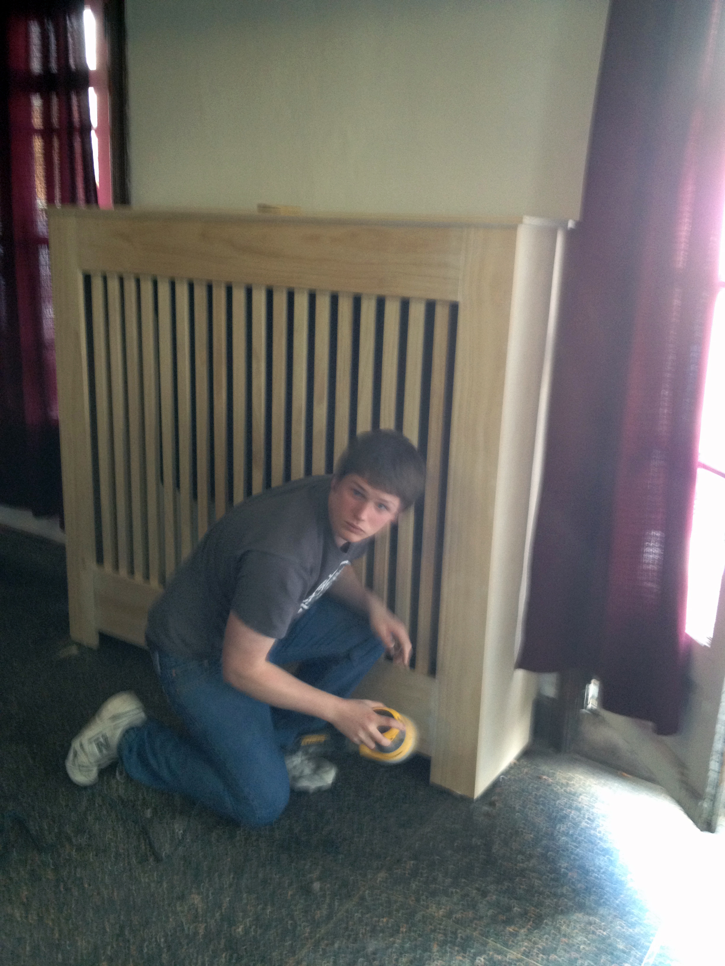  2013 Alumni Work Weekend - Pool Room Project Ian Maxwell puts the final touches on the new radiator covers 