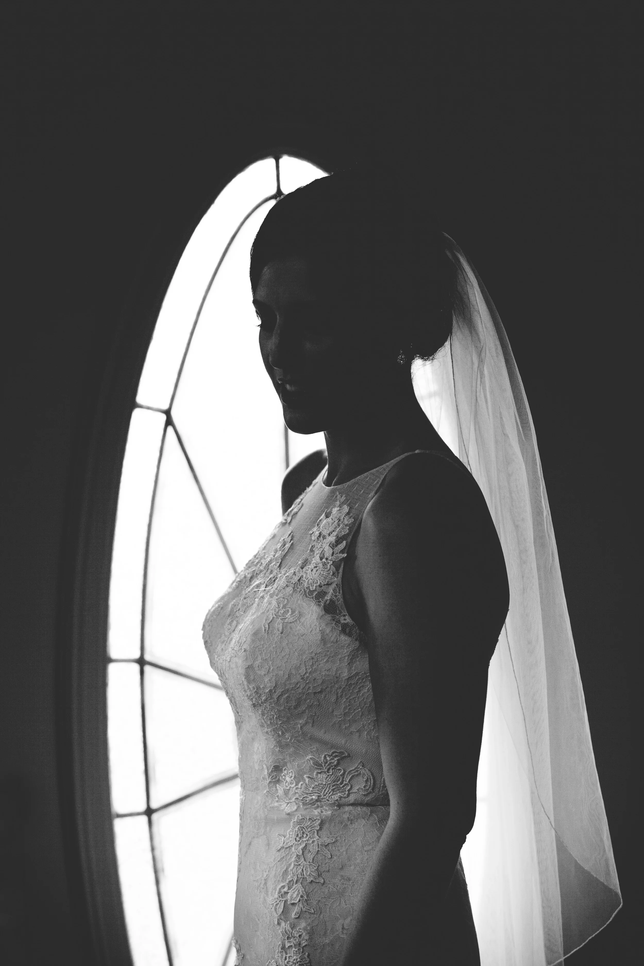 A unique silhouette shot from the window pane of the Bride's house.