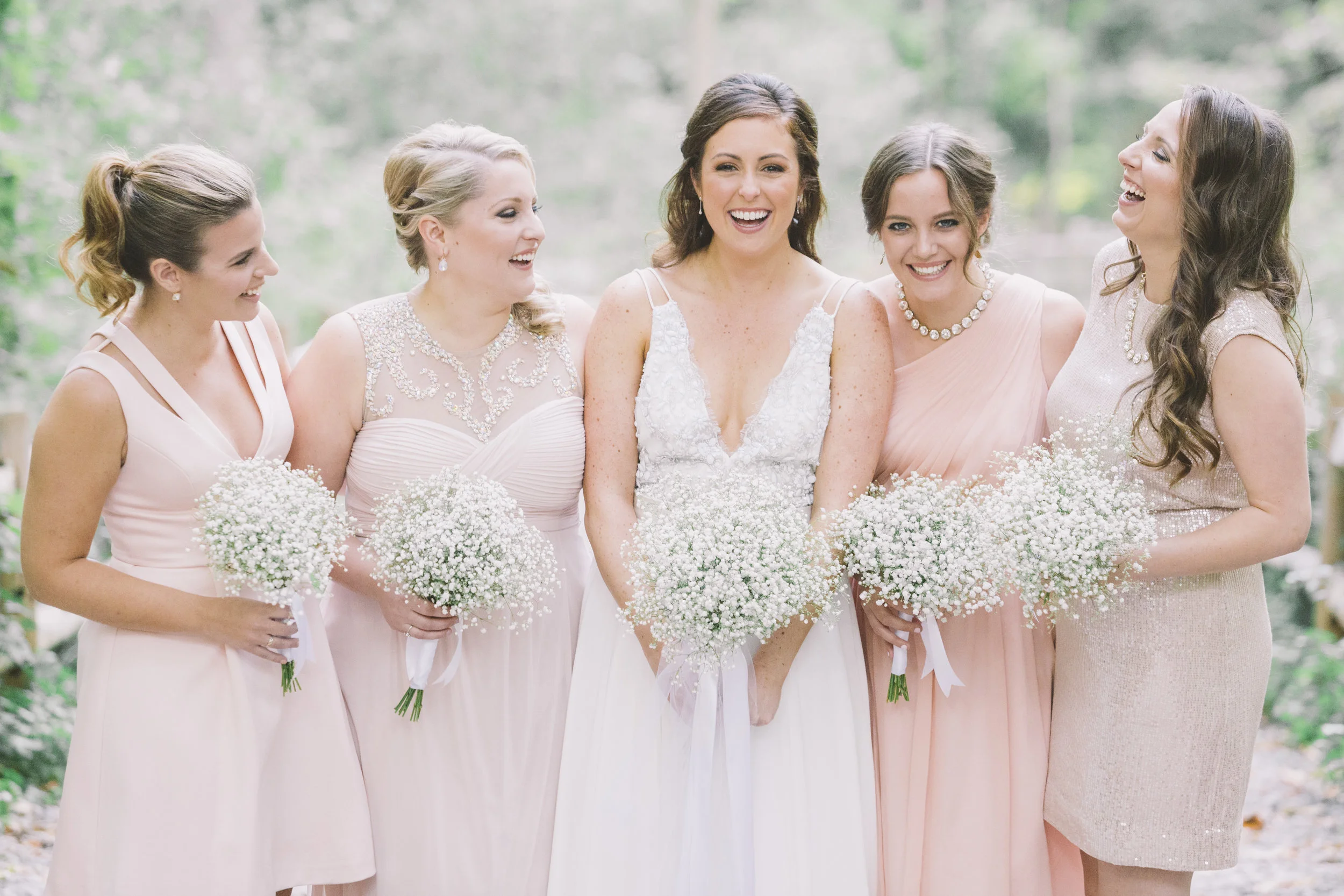 bridesmaids and bride laughing 