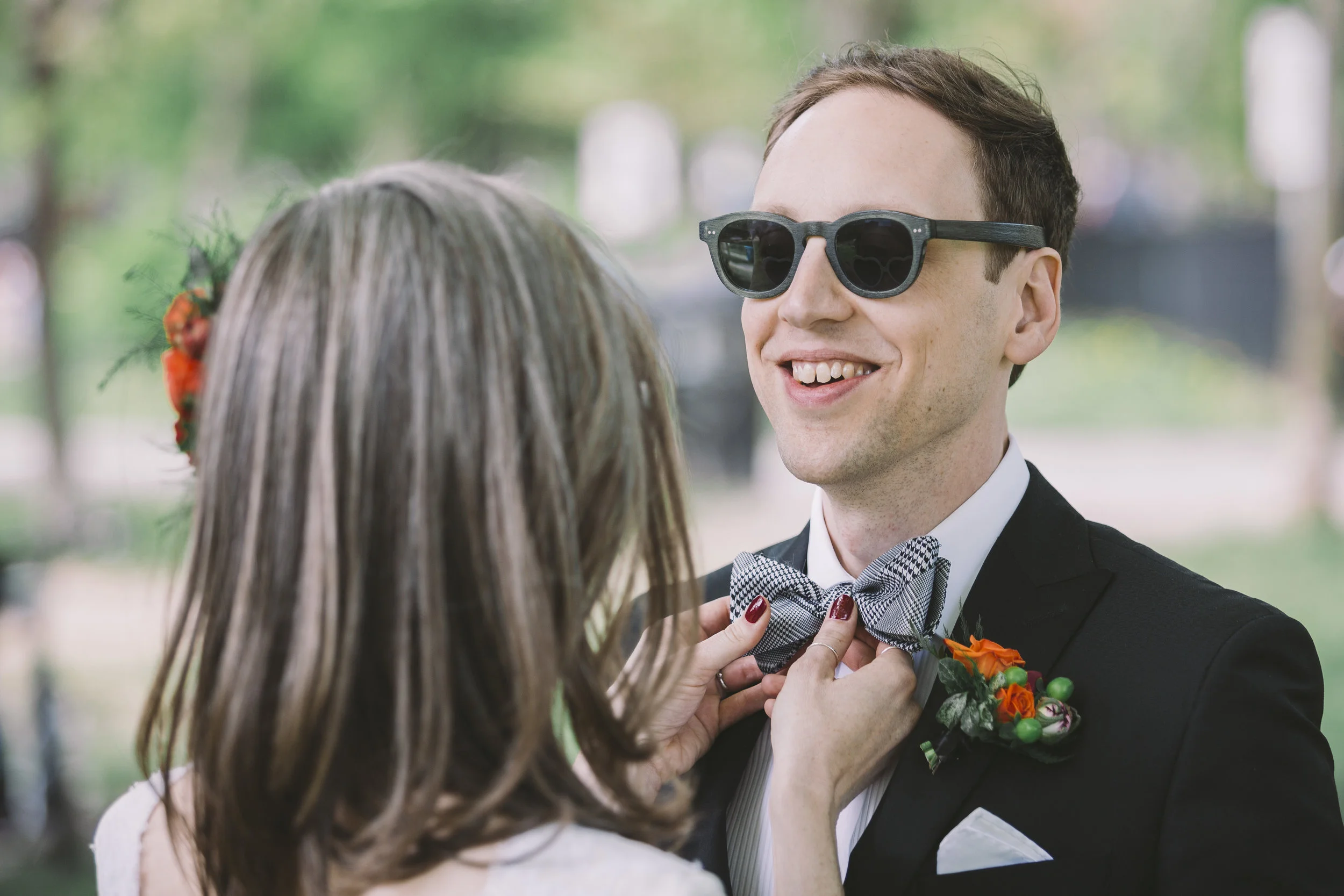 Wedding Couple Adjusting Bowtie in Trinity Bellwoods Park