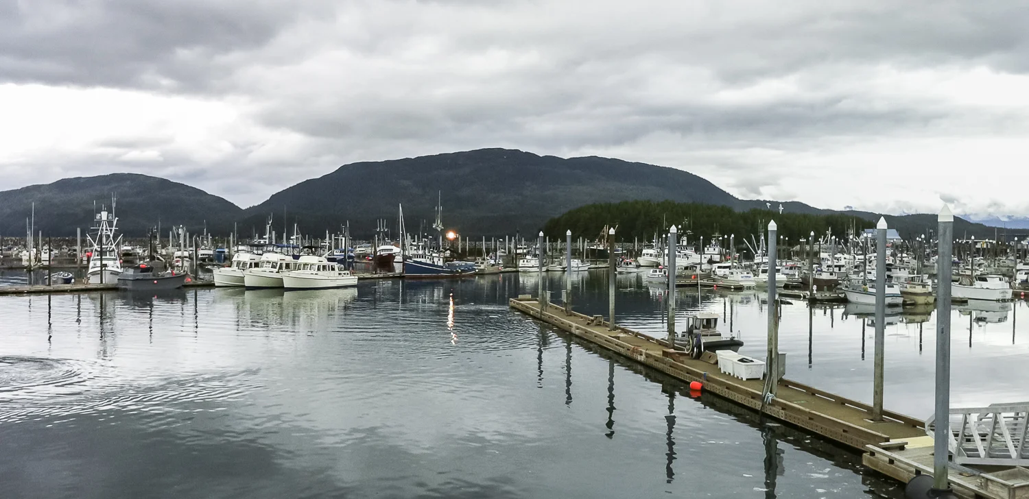 The "pleasure yachts" stand out in the working harbor of Cordova