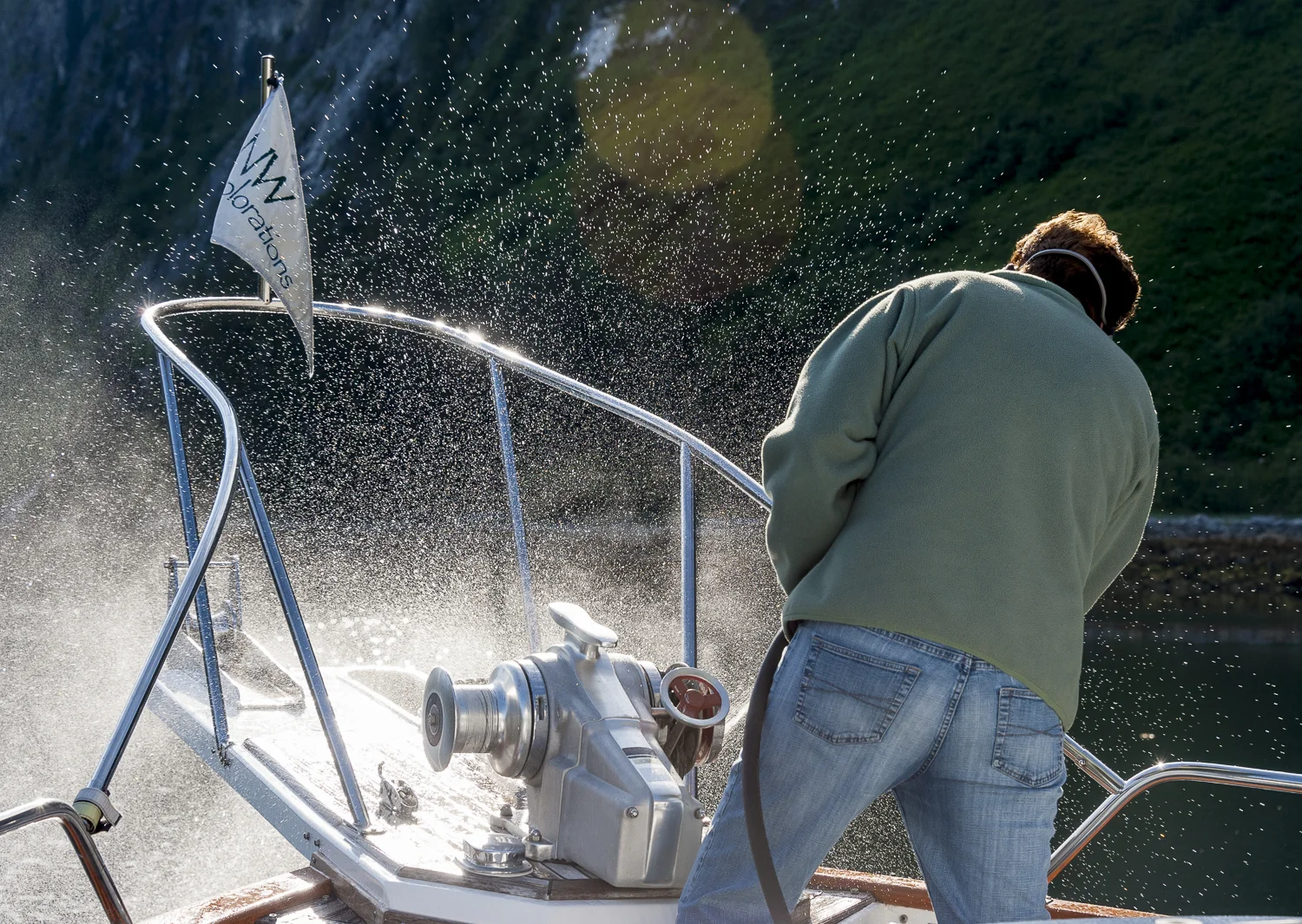 Karen, the master of the windless, cleans the anchor chain as she brings it on board