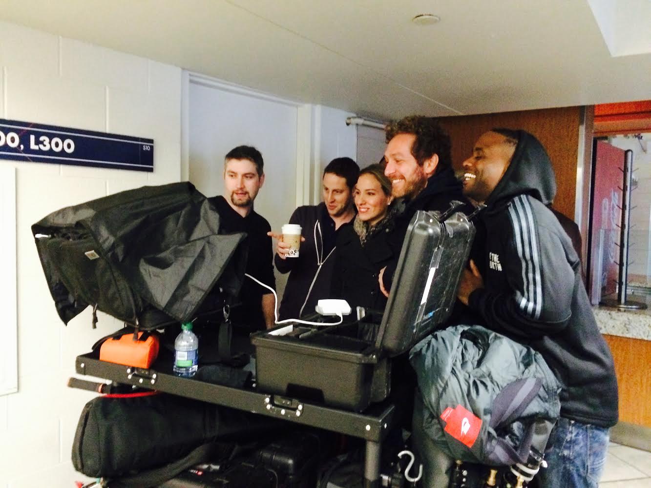 The creative crew going over selects from the shoot - note the rain gear.